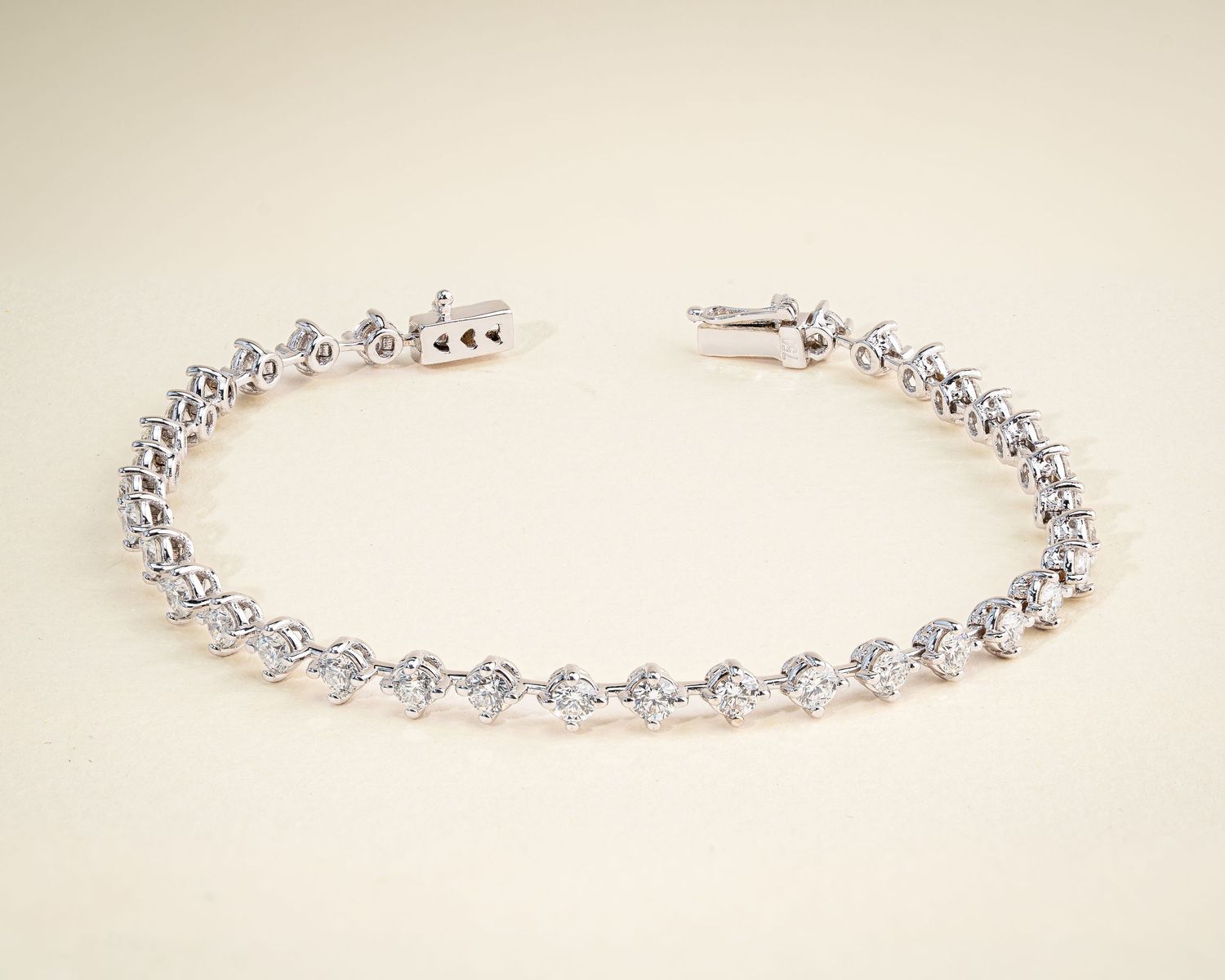 Elegant crystal tennis bracelet with prong-set stones in silver finish.