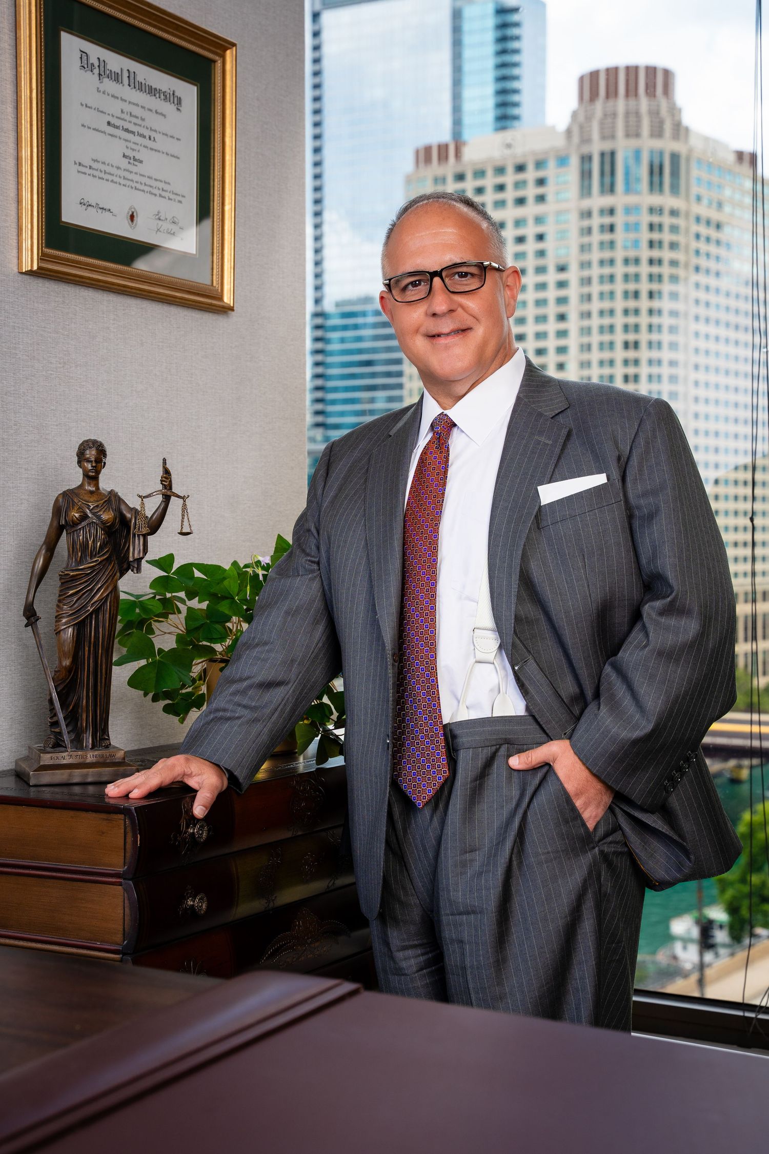 Executive office interior with city skyline view and legal decorative elements.