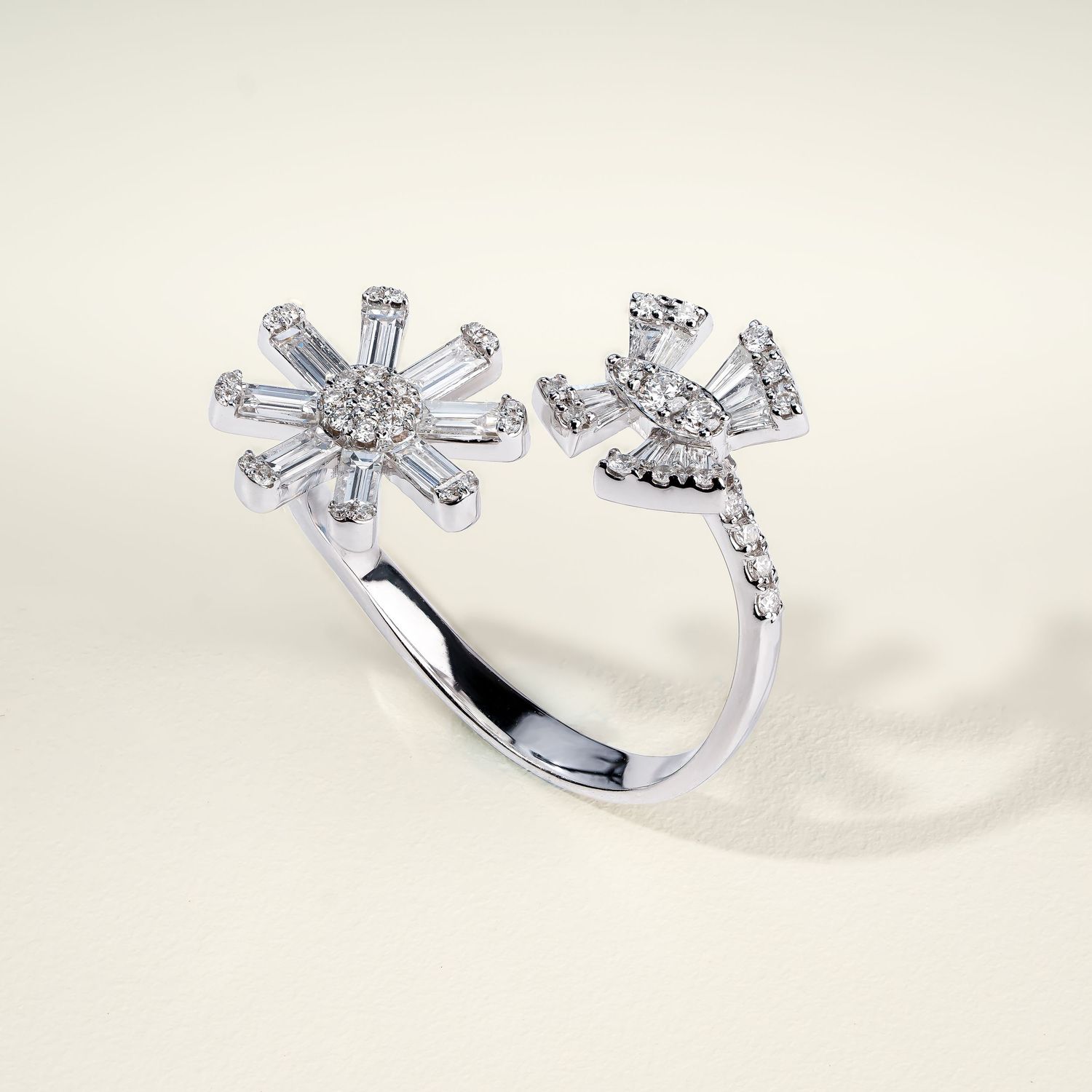 White gold flower-shaped ring with diamond petals and center stone shown in rotating views.