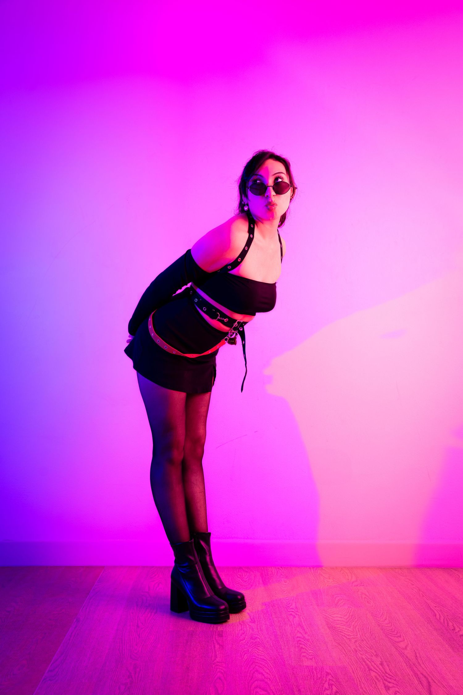 Artistic dance silhouettes against neon pink backdrop showing fluid movement.