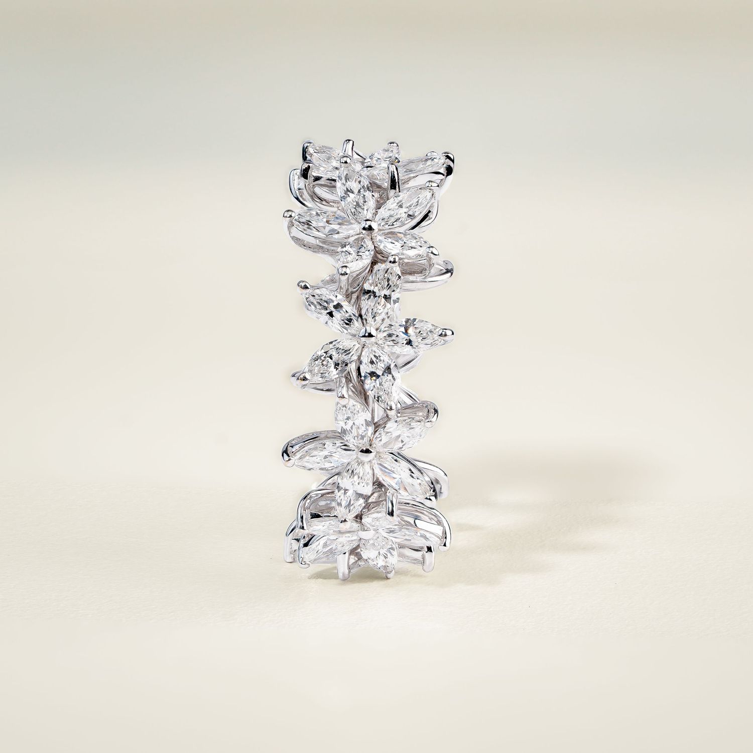 White gold floral drop pendant with multiple diamond clusters shown from different angles.