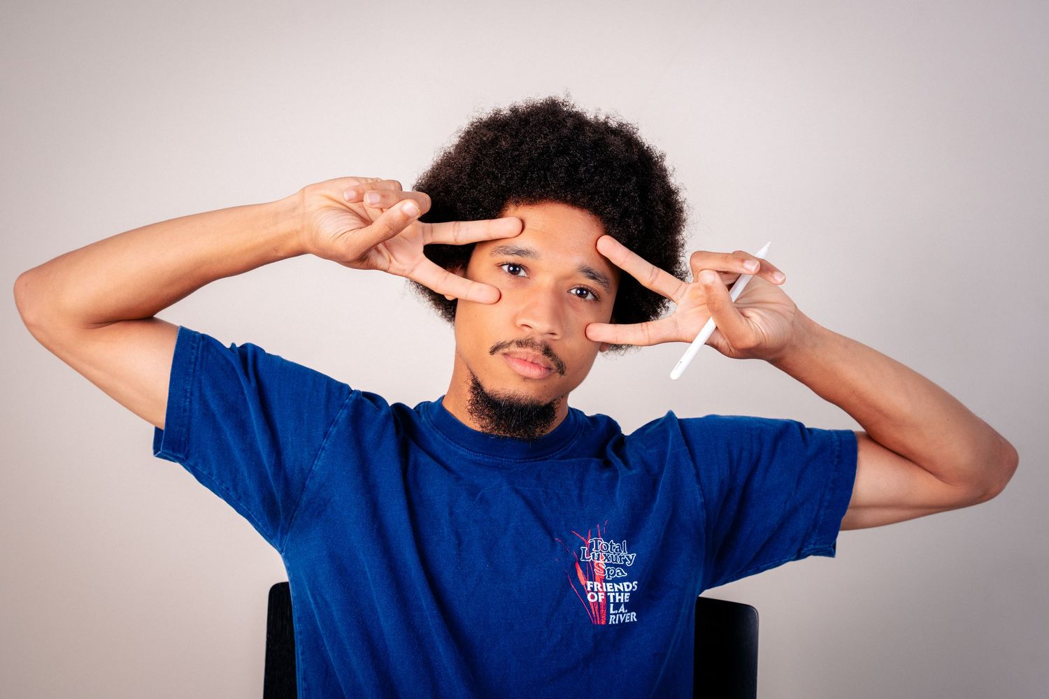 Person demonstrating various animated expressions in studio photoshoot.