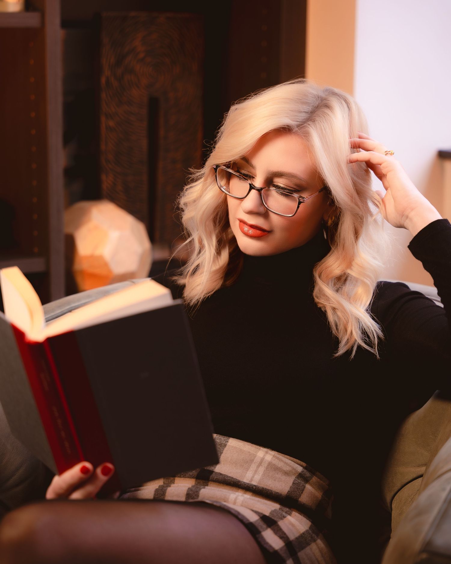 Artistic photoshoot sequence featuring platinum blonde hair and red lipstick in warm lighting.