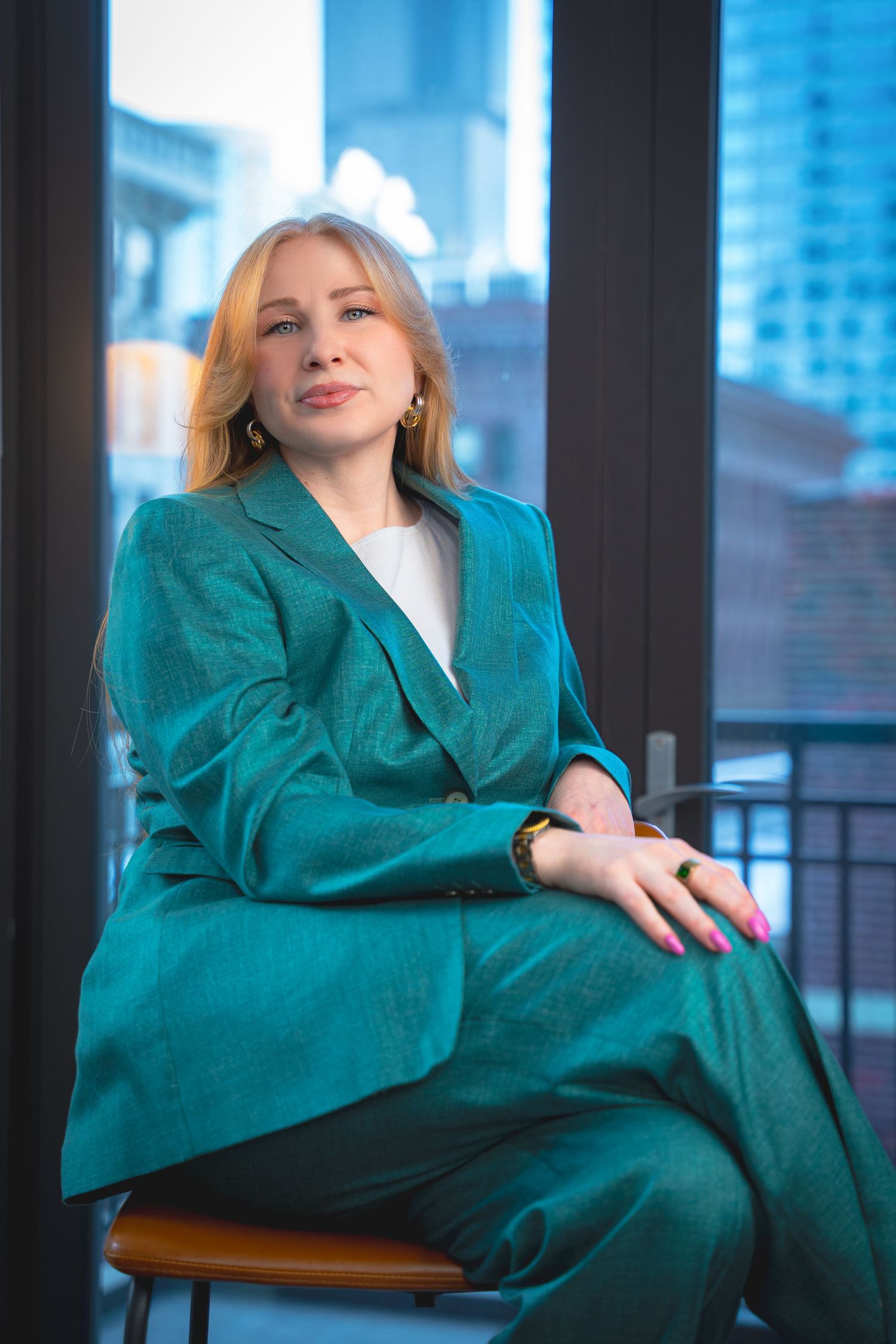 Person in a vibrant teal blazer poses confidently across multiple artistic portrait shots.