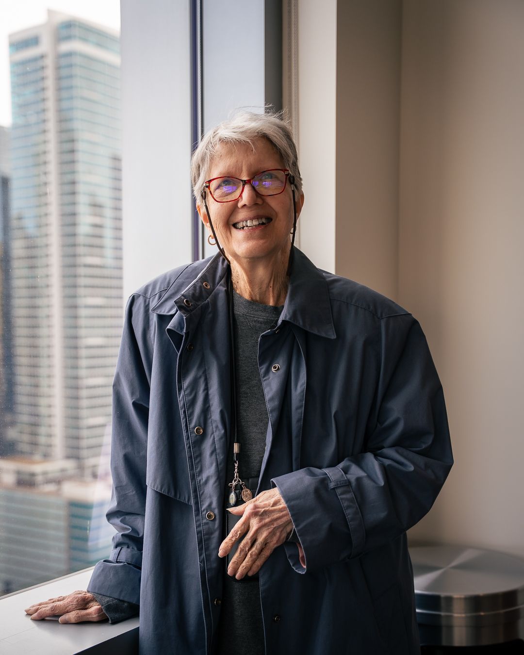 Professional portrait series by window showing warm expressions in natural light.