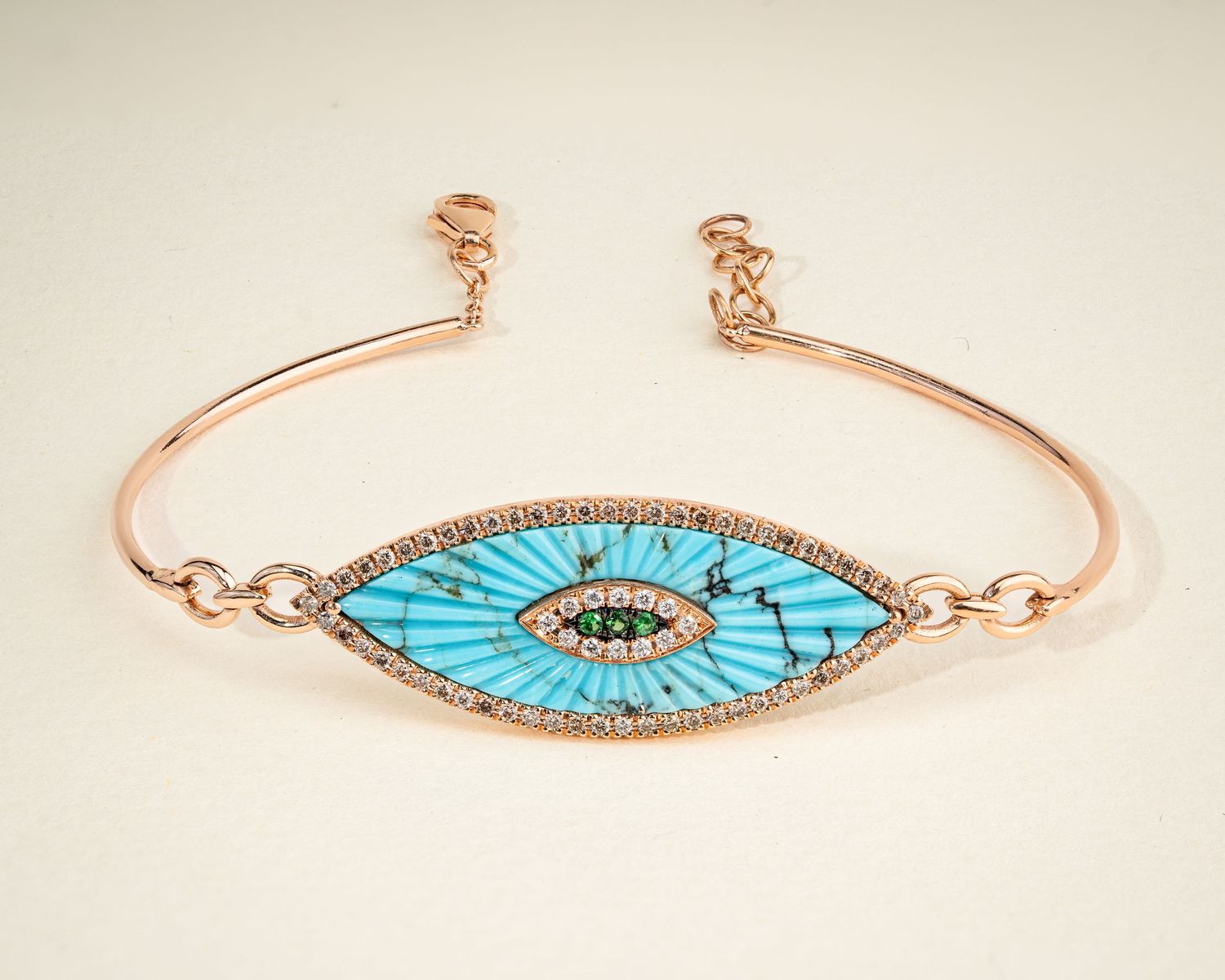 Delicate rose gold bracelets with turquoise evil eye designs and crystal embellishments.