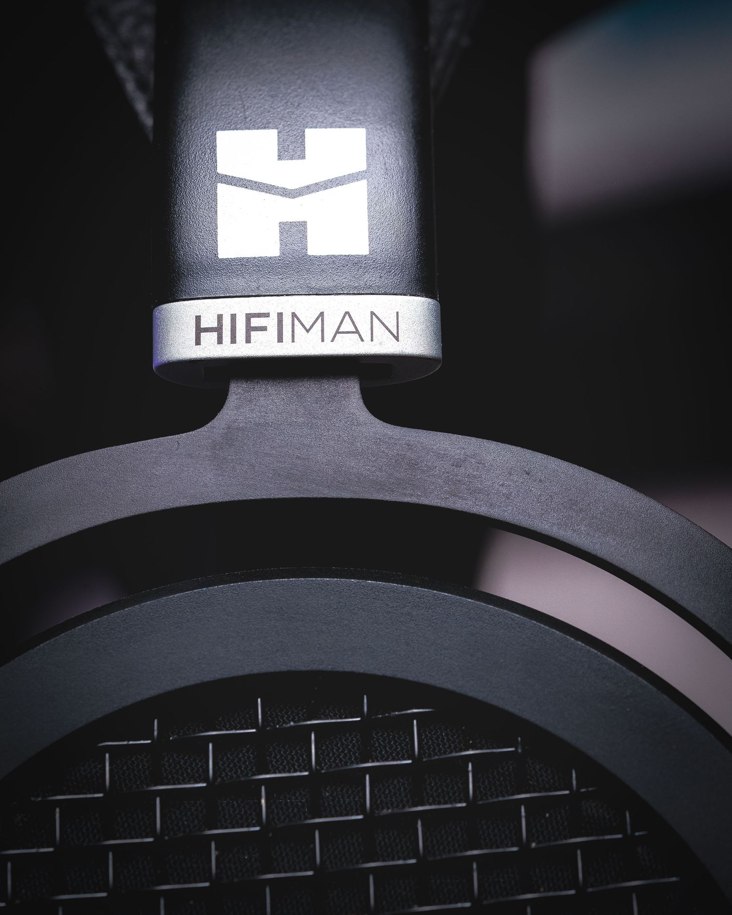 Close-up view of a black Hifiman headphone headband showing the company logo and textured design details.