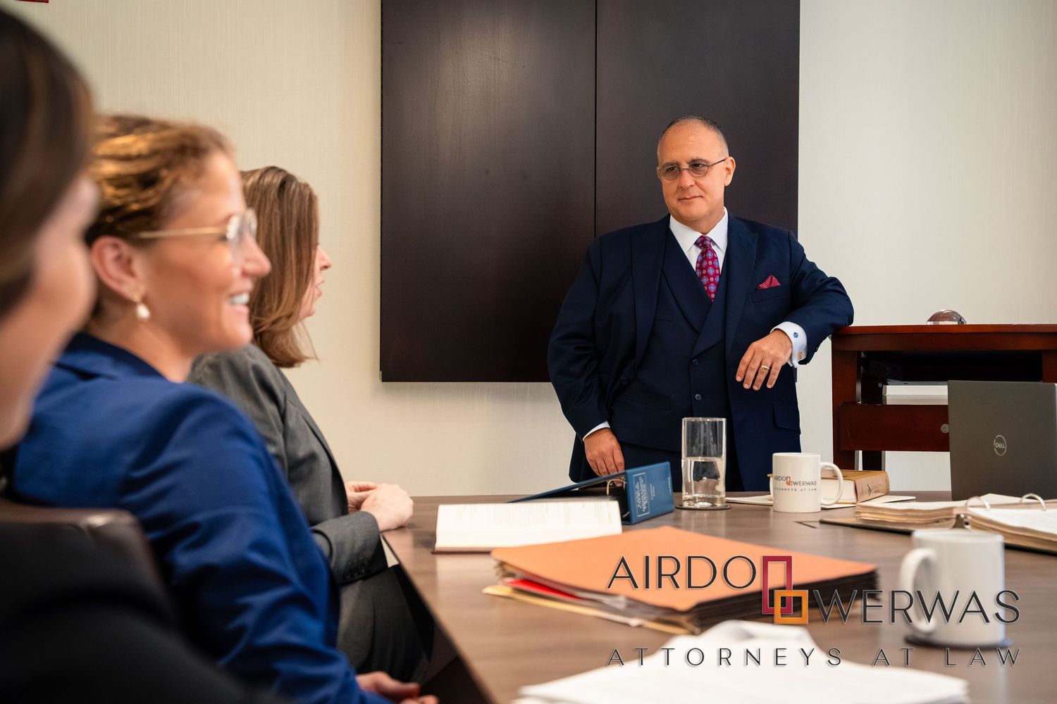 Legal team conducting business meeting in professional conference room.