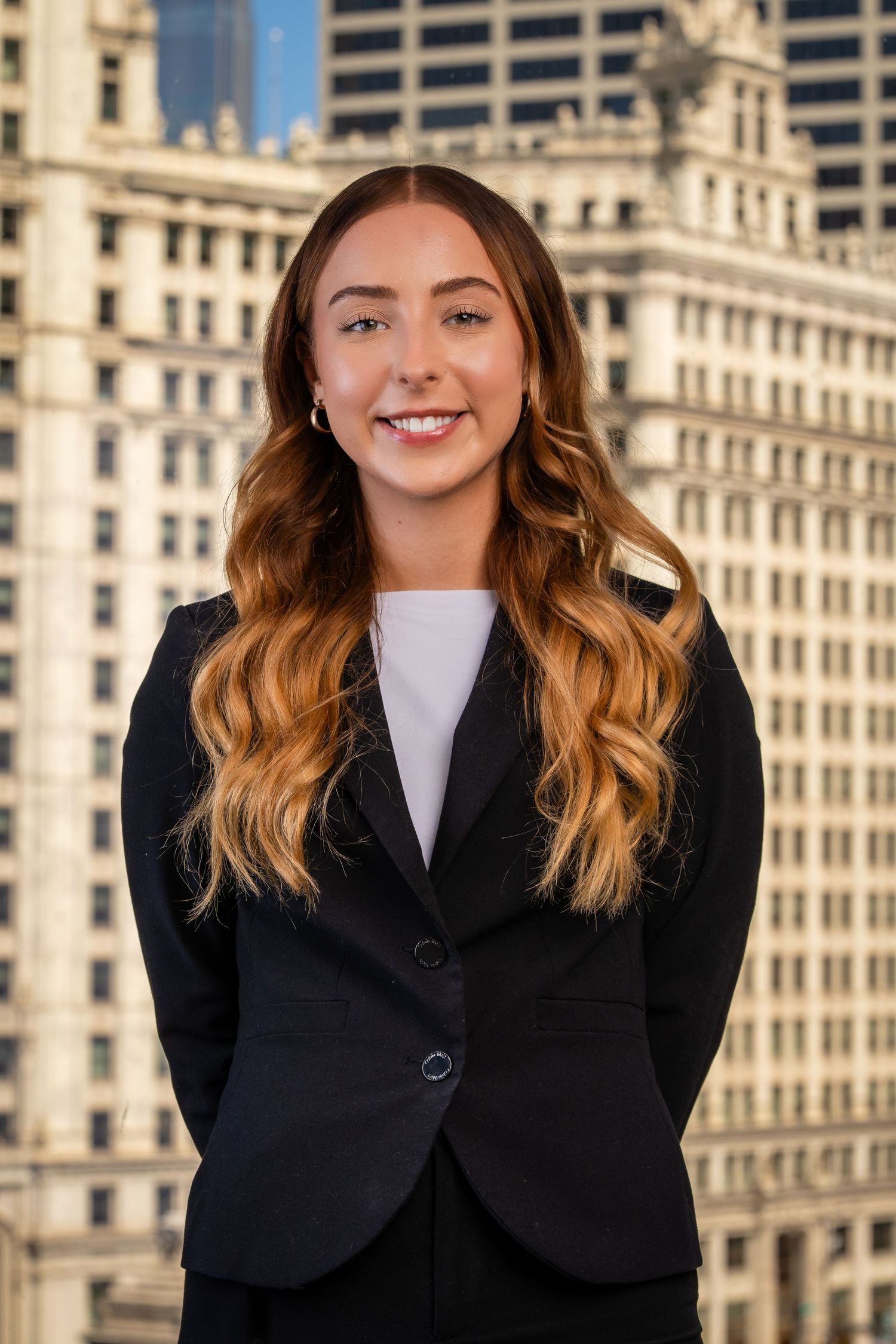 Professional portraits against classic architecture wearing black business attire.