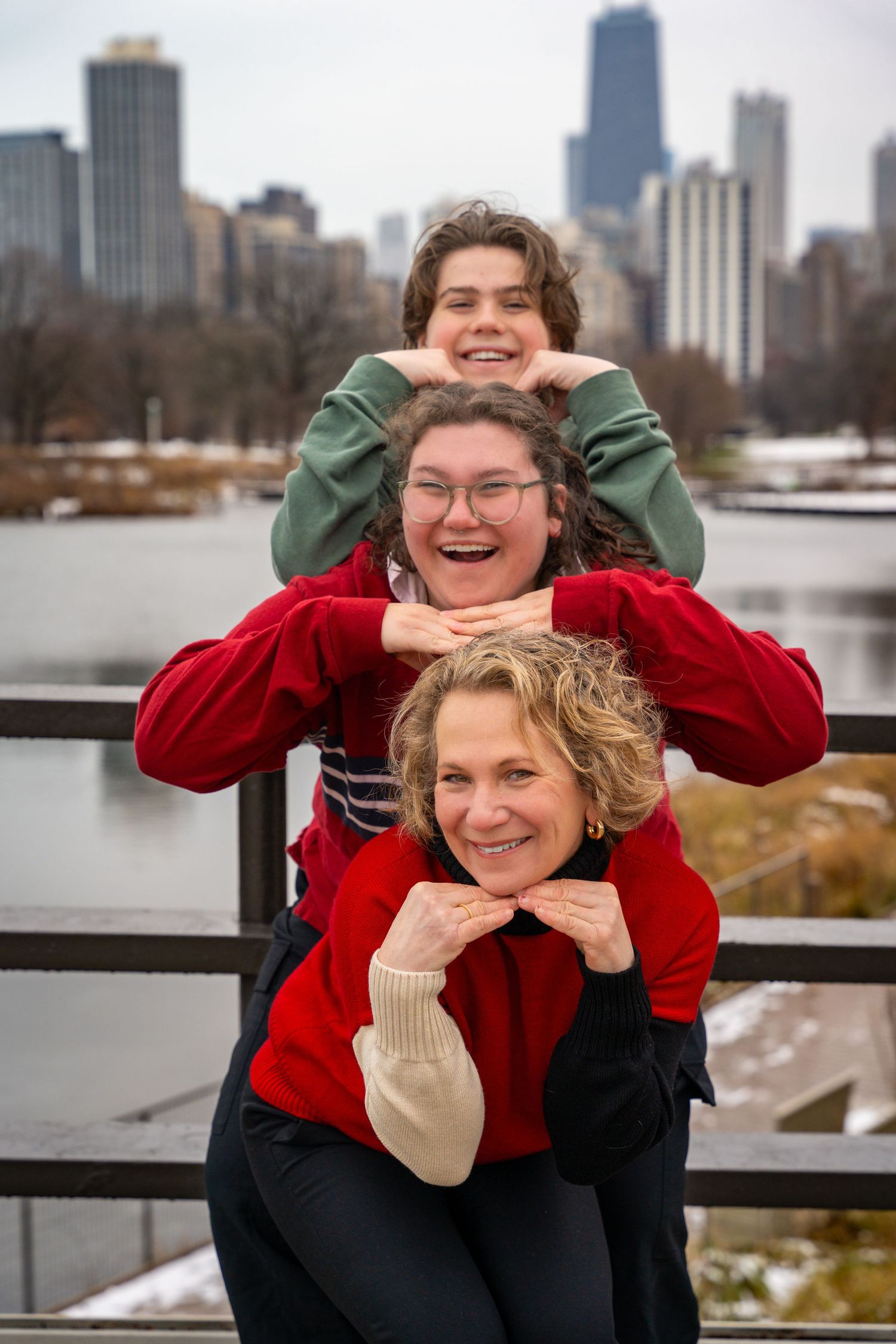 Two people pose playfully in front of the Chicago skyline on a winter day, creating a series of candid shots.