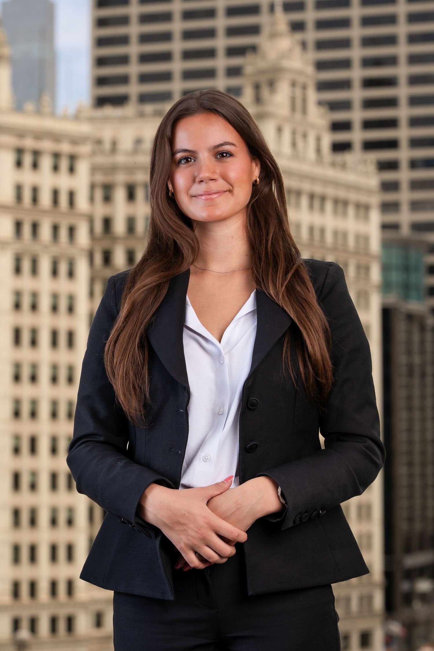 Professional headshots featuring black blazer and white shirt against city architecture.