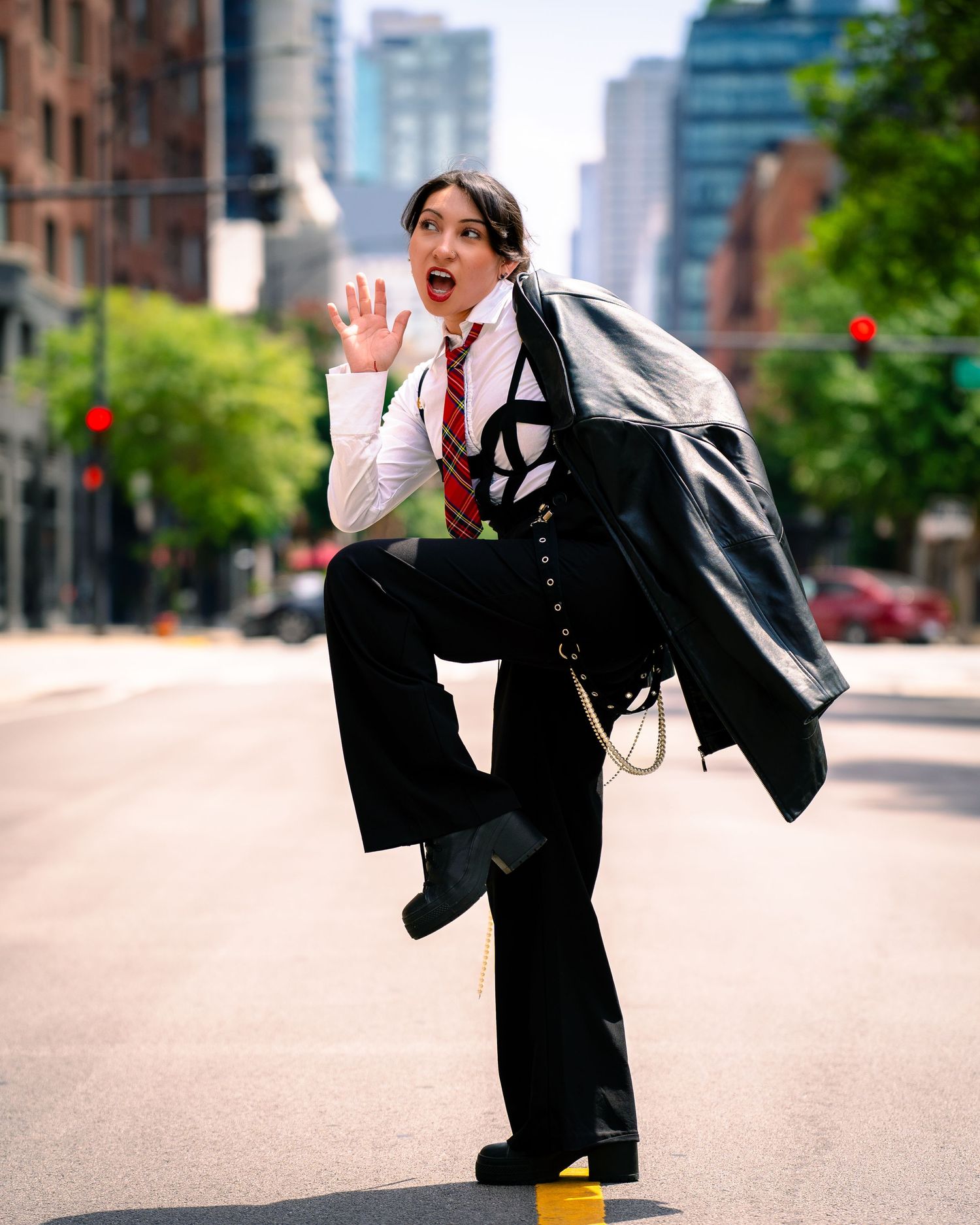 Energetic street style photo showing playful jumping pose in business attire.