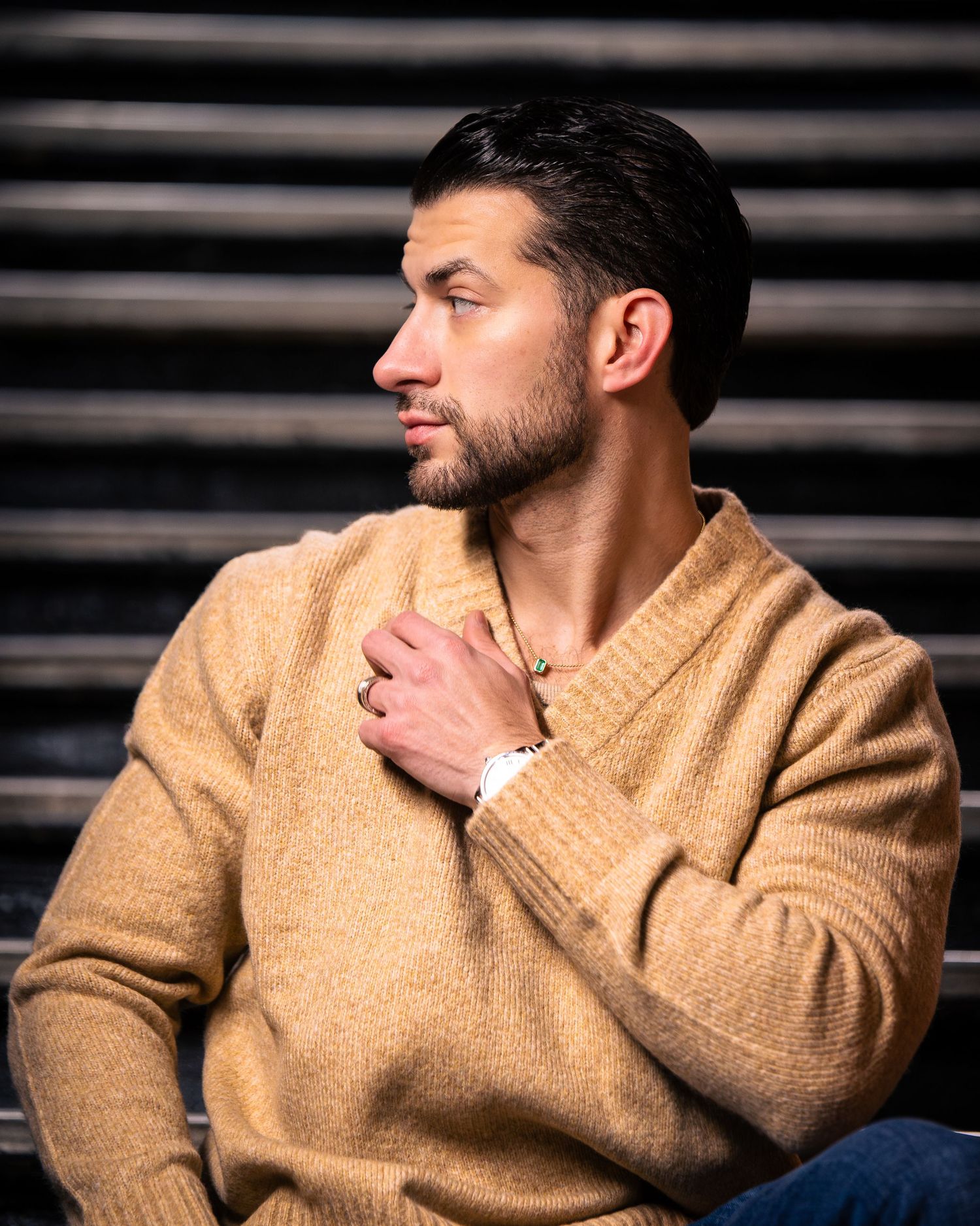 Portrait sequence showing contemplative poses in beige sweater against dark background.