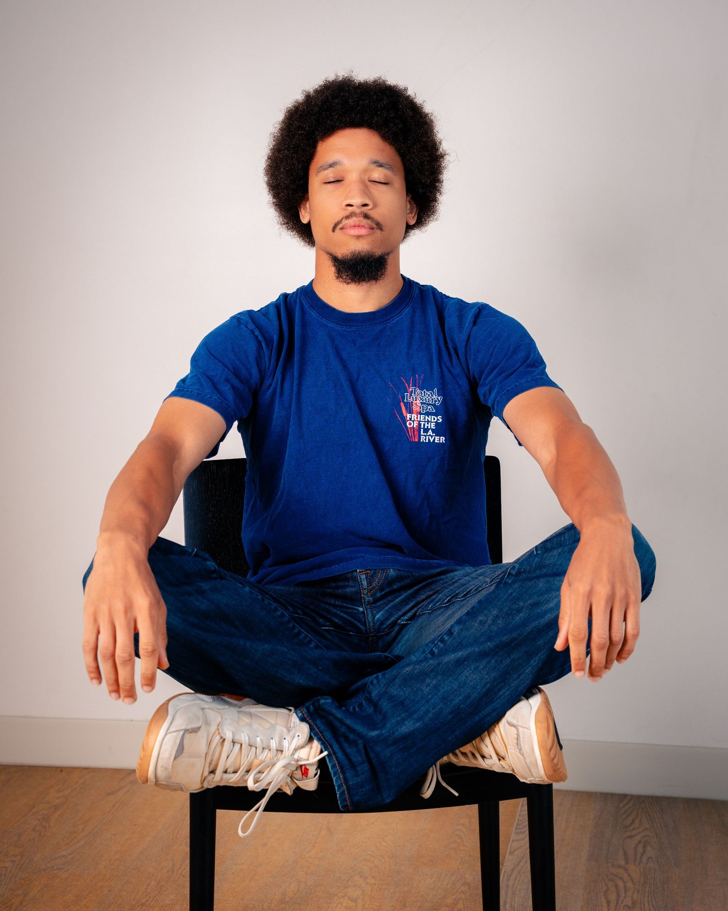 Person seated on chair showing relaxed poses in studio setting.