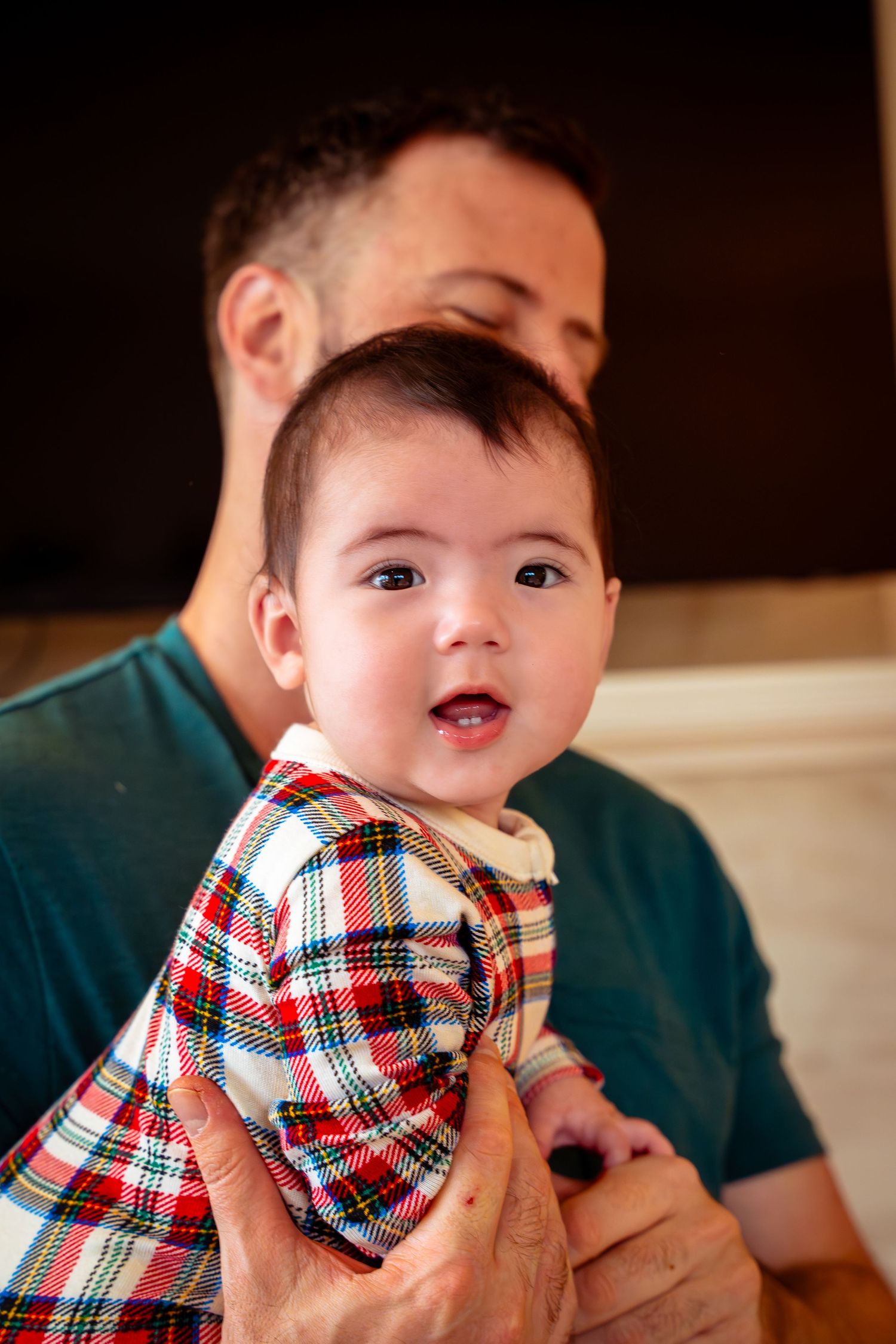 A series of photos showing a young child in a red and white plaid bow tie making playful expressions.