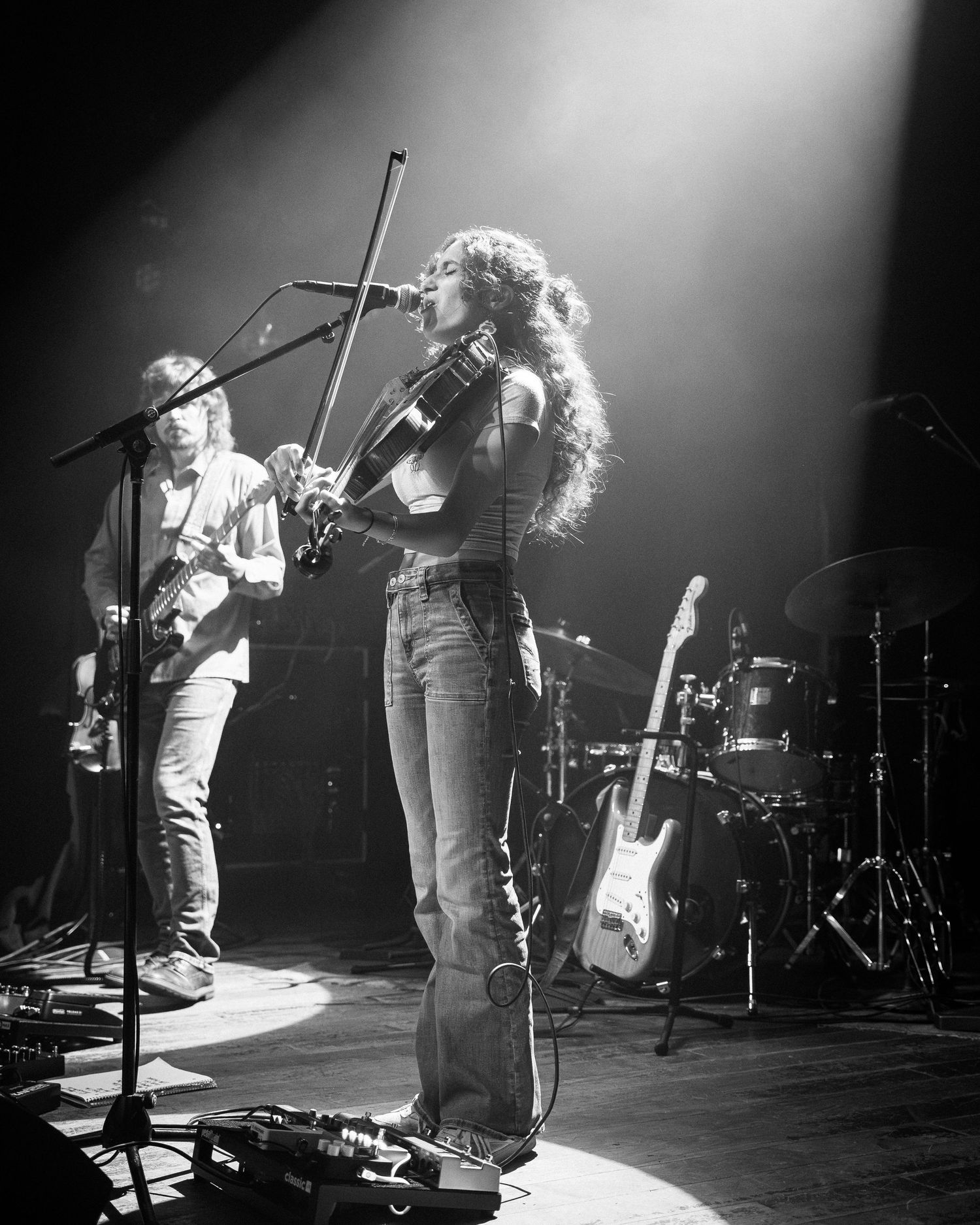 Black and white concert photos showing performers on stage with dramatic lighting and silhouettes.