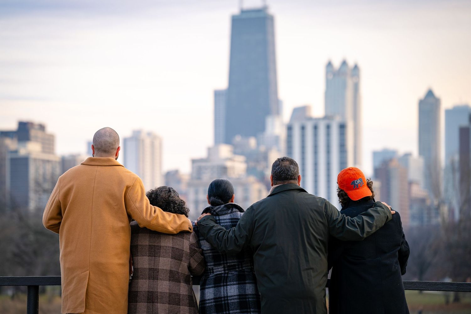 Group of people admiring Chicago skyline together on a cloudy day.