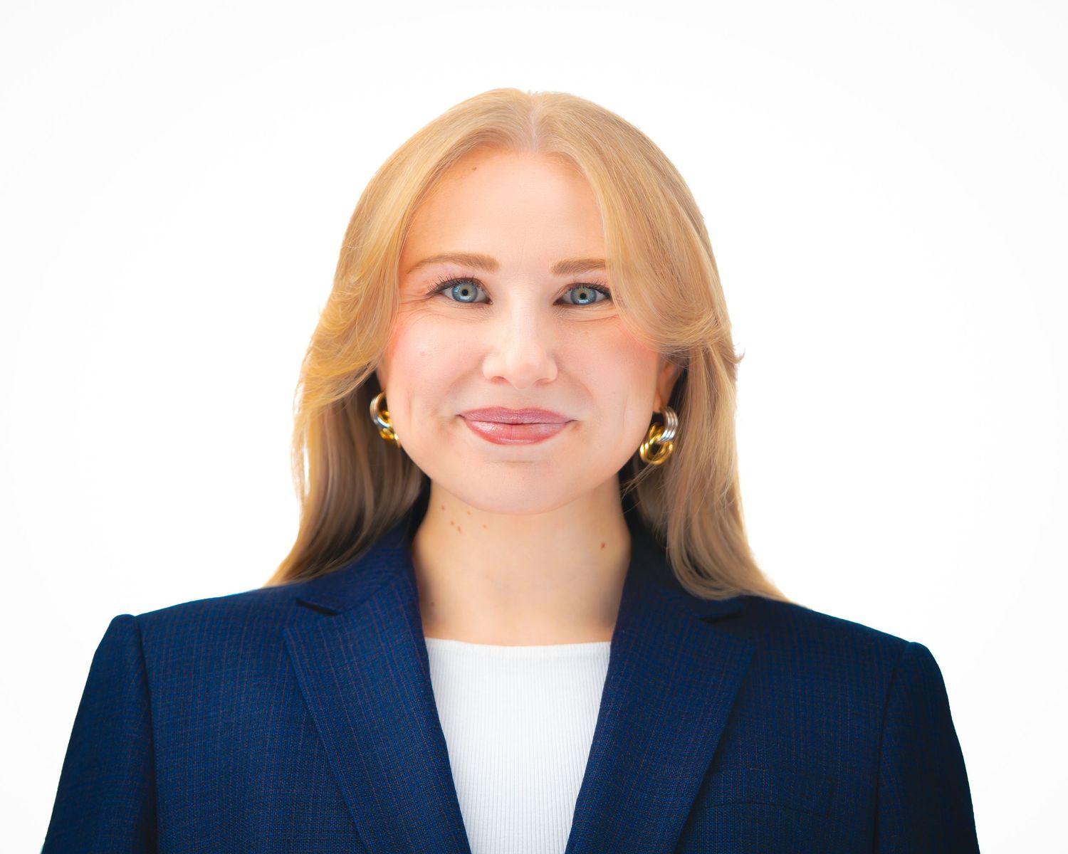 Professional business headshots of three women in navy blazers and white blouses against a white background.