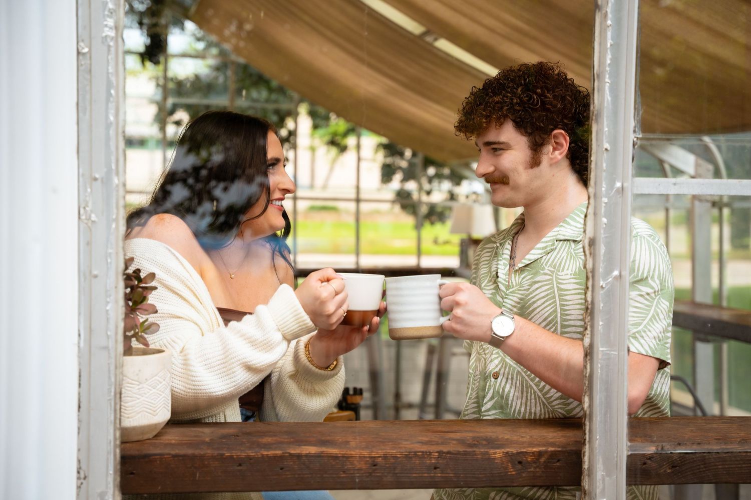 Friends enjoying coffee and conversation at an outdoor cafe table.