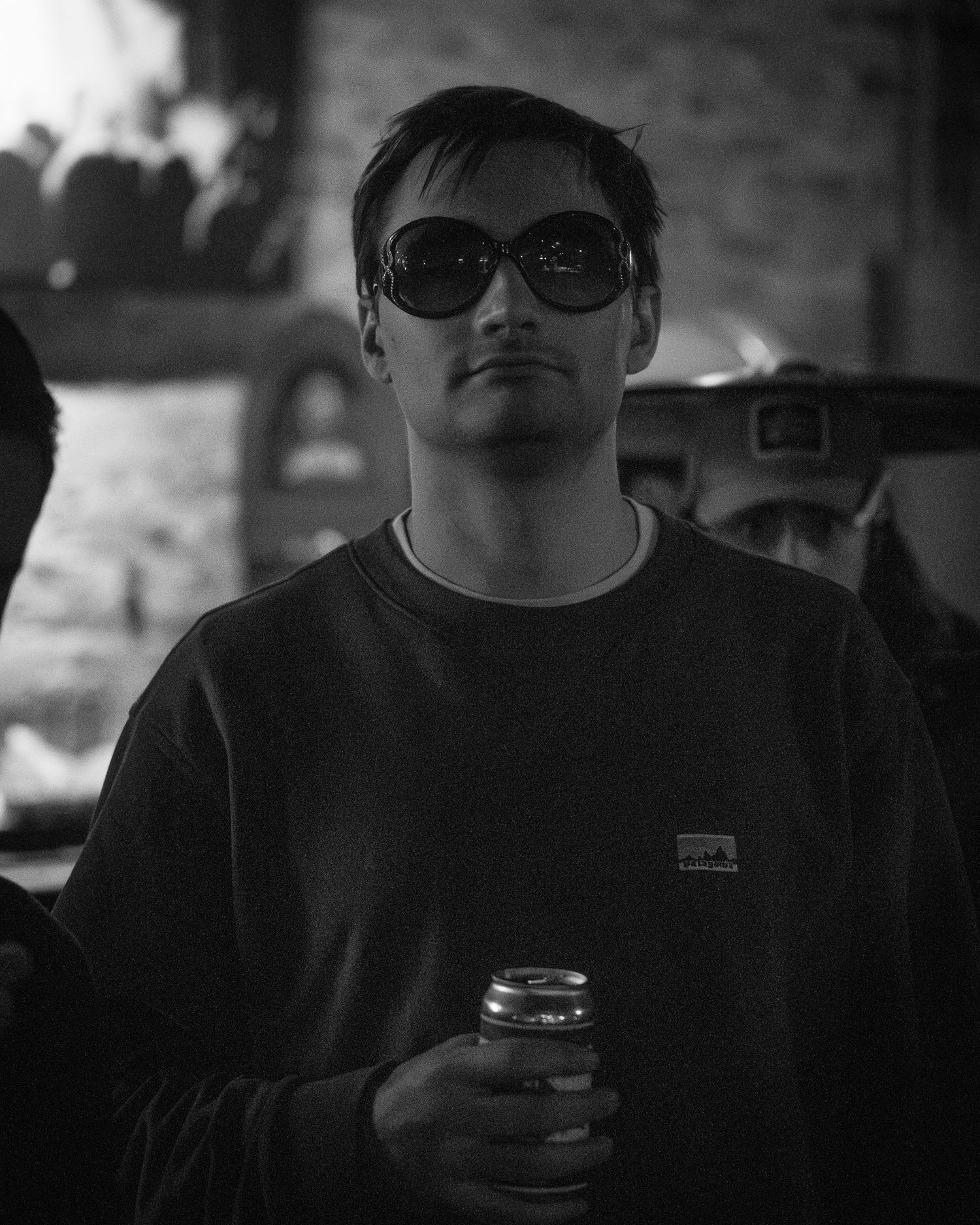 Monochrome shot of people wearing sunglasses and casual clothing.