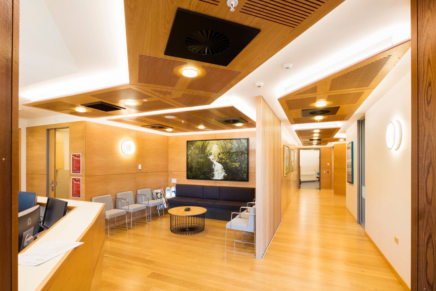 Modern hallway interior with wood paneling and recessed lighting creating warm ambiance.