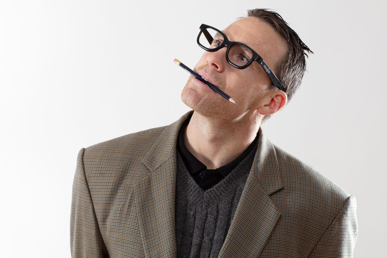 Studio portraits showing playful expressions against white background.