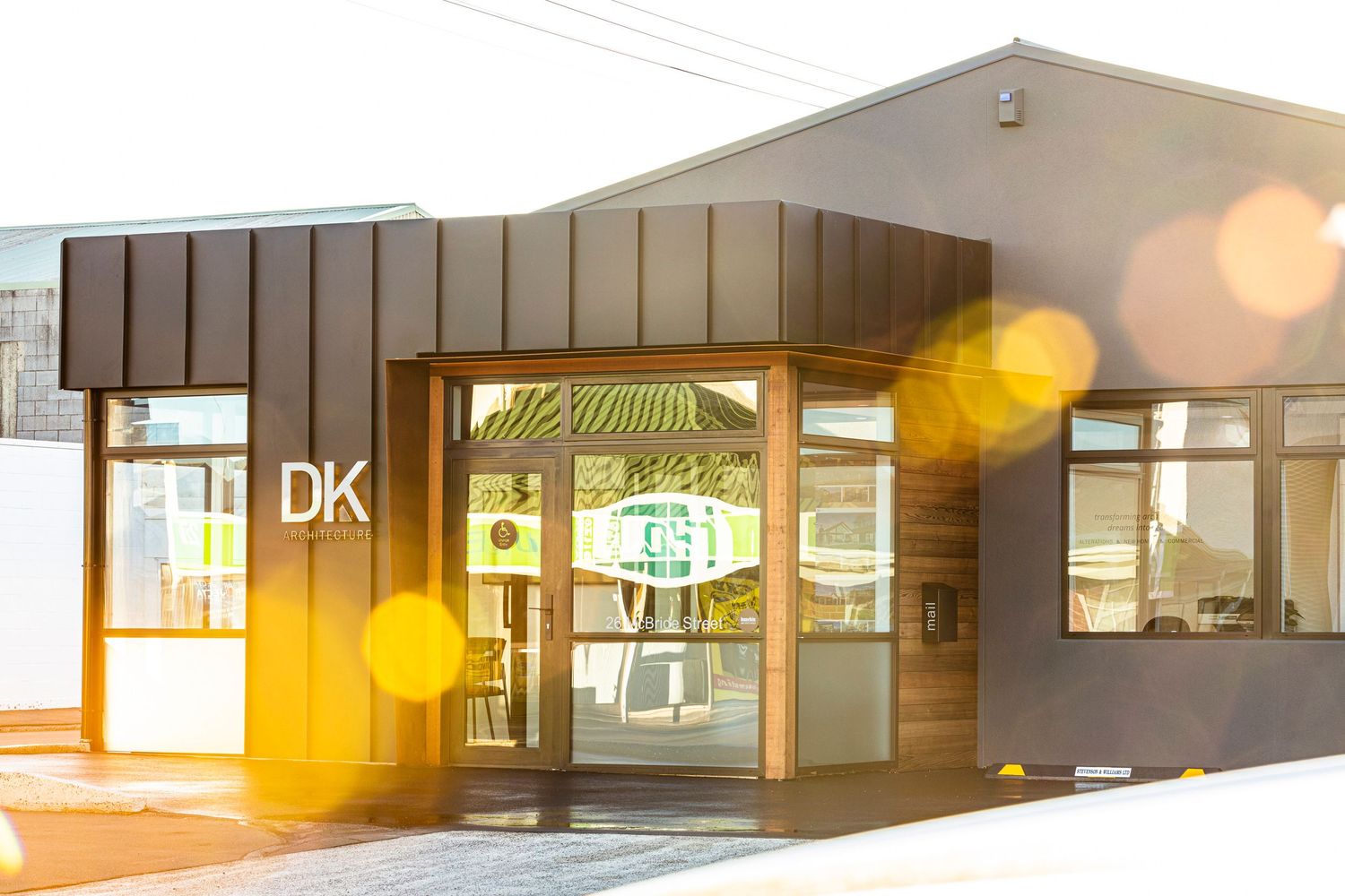 Panoramic view of modern office space with glass walls and open floor plan design.