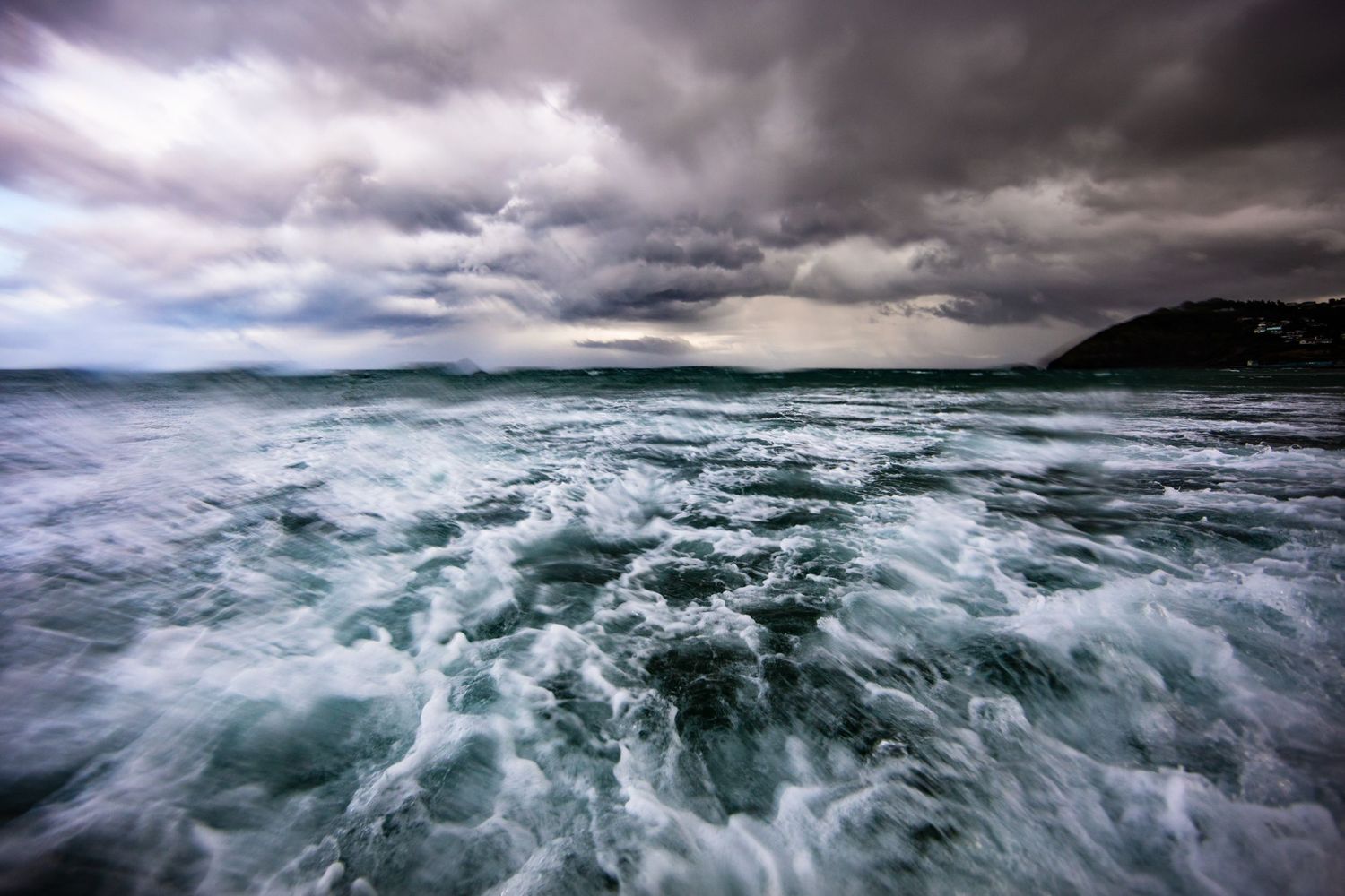 Stormy seas with dramatic waves and dark clouds creating an intense seascape.