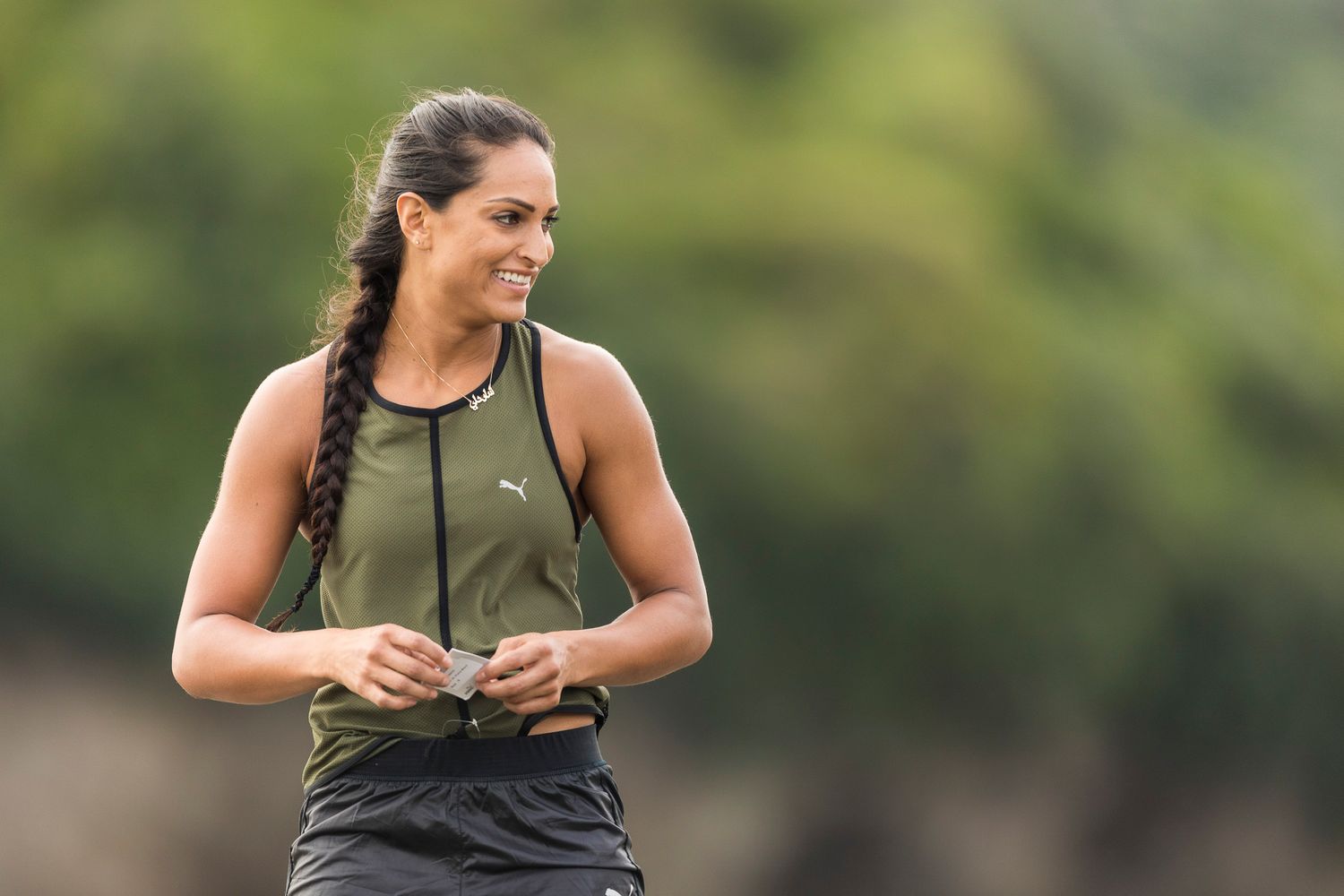 Athletic person in workout gear standing outdoors during training session.