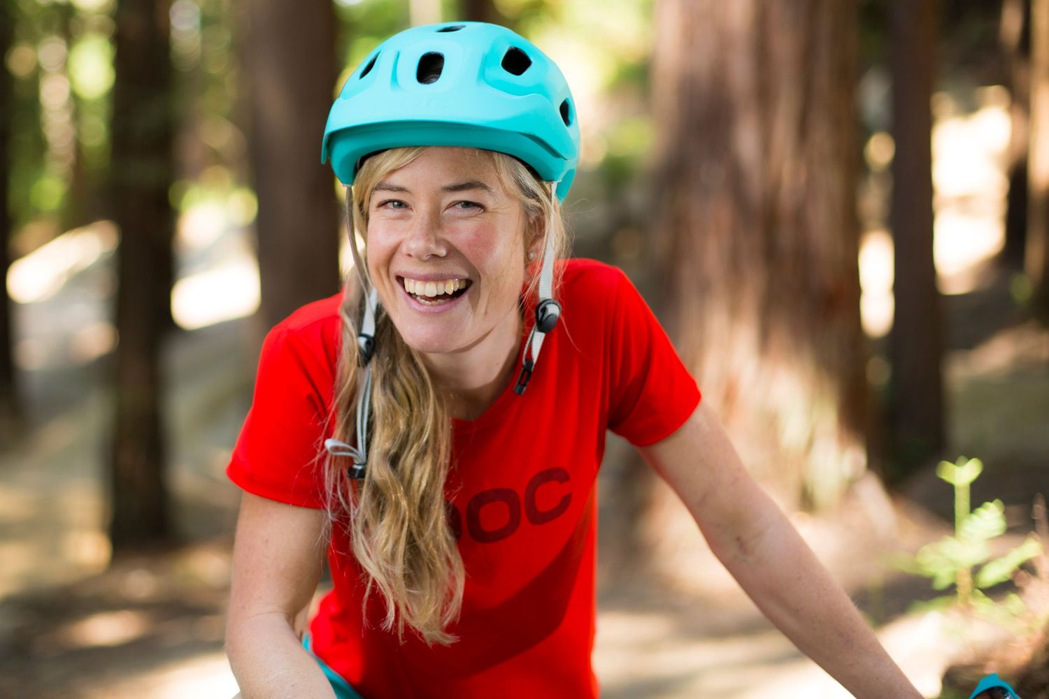Mountain biking action shots in a wooded forest trail wearing safety gear.