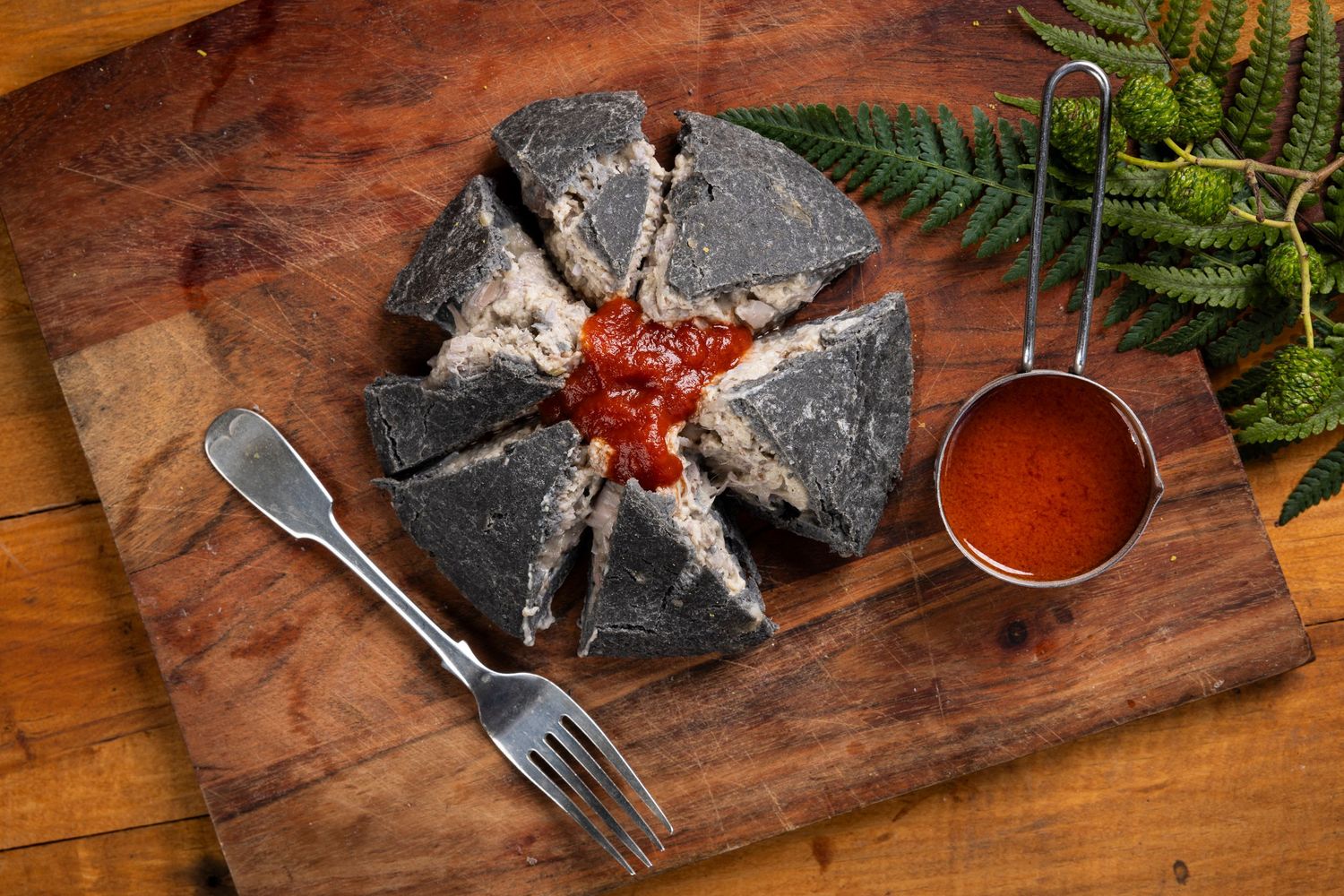 Crusty bread and seafood arranged on rustic wooden serving boards with herbs and sauce.