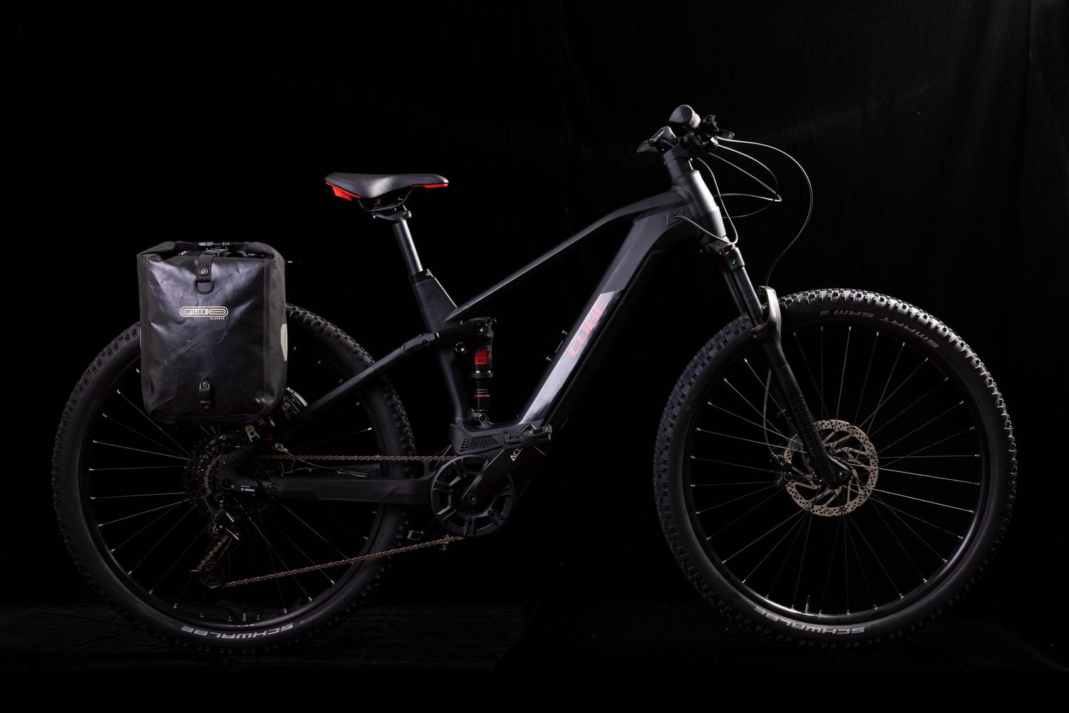 Series of mountain bikes silhouetted against dark background showing various angles and models.