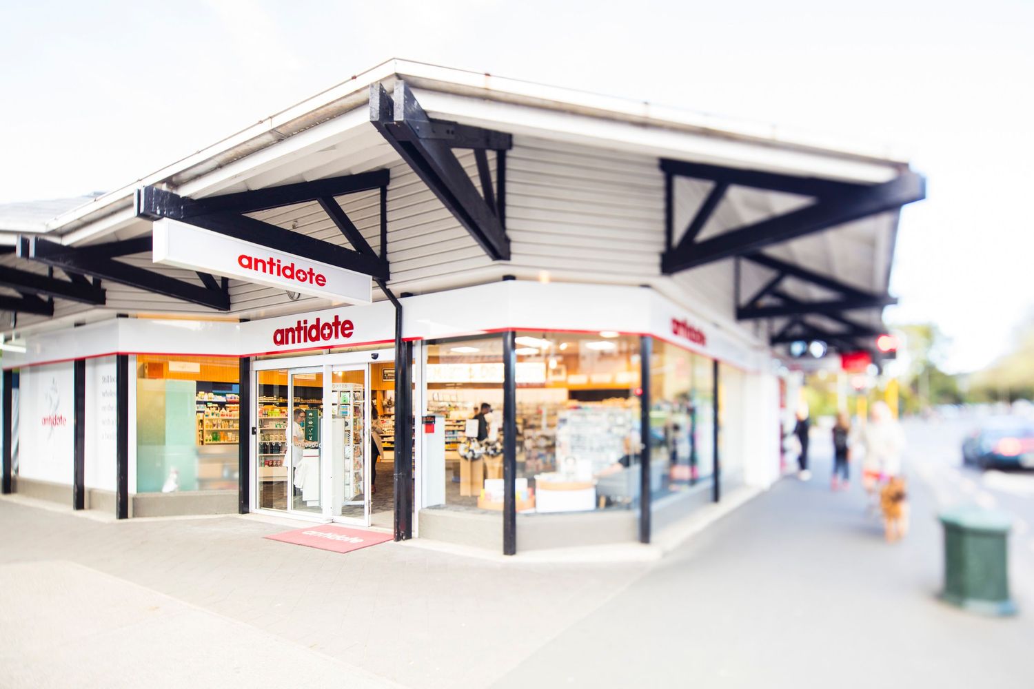 Strip mall exterior with white siding and angular awnings in selective focus.