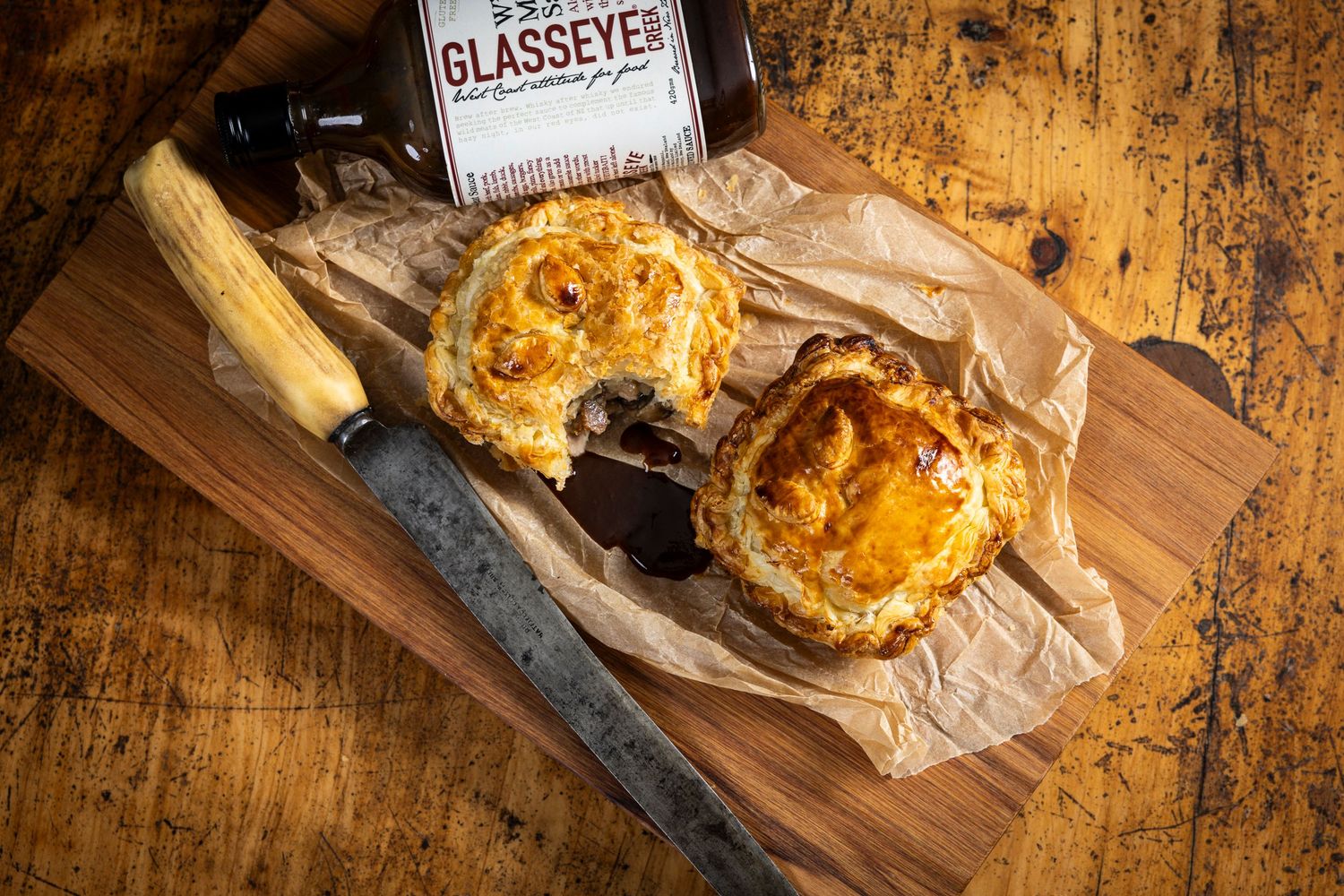 Golden pastries presented on wooden boards with vintage styling and warm lighting.