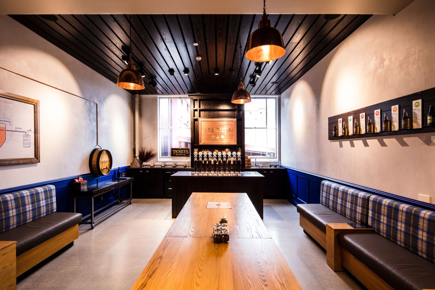 Cozy restaurant booth seating with wooden table and pendant lighting.
