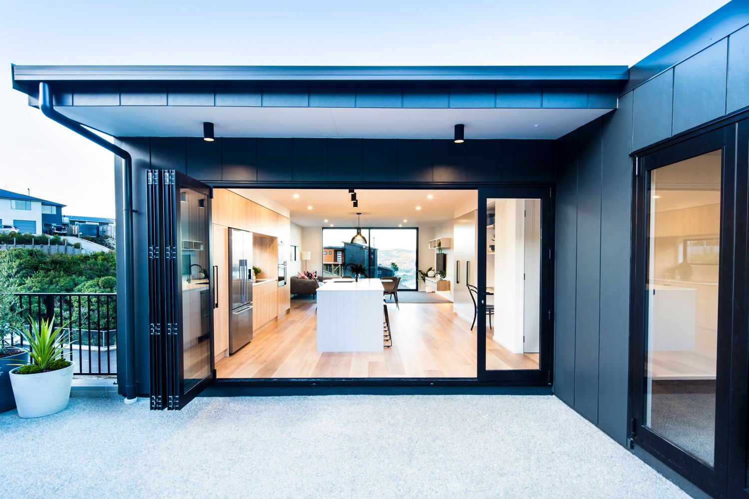 Modern black exterior building facade with large windows and minimalist design features.