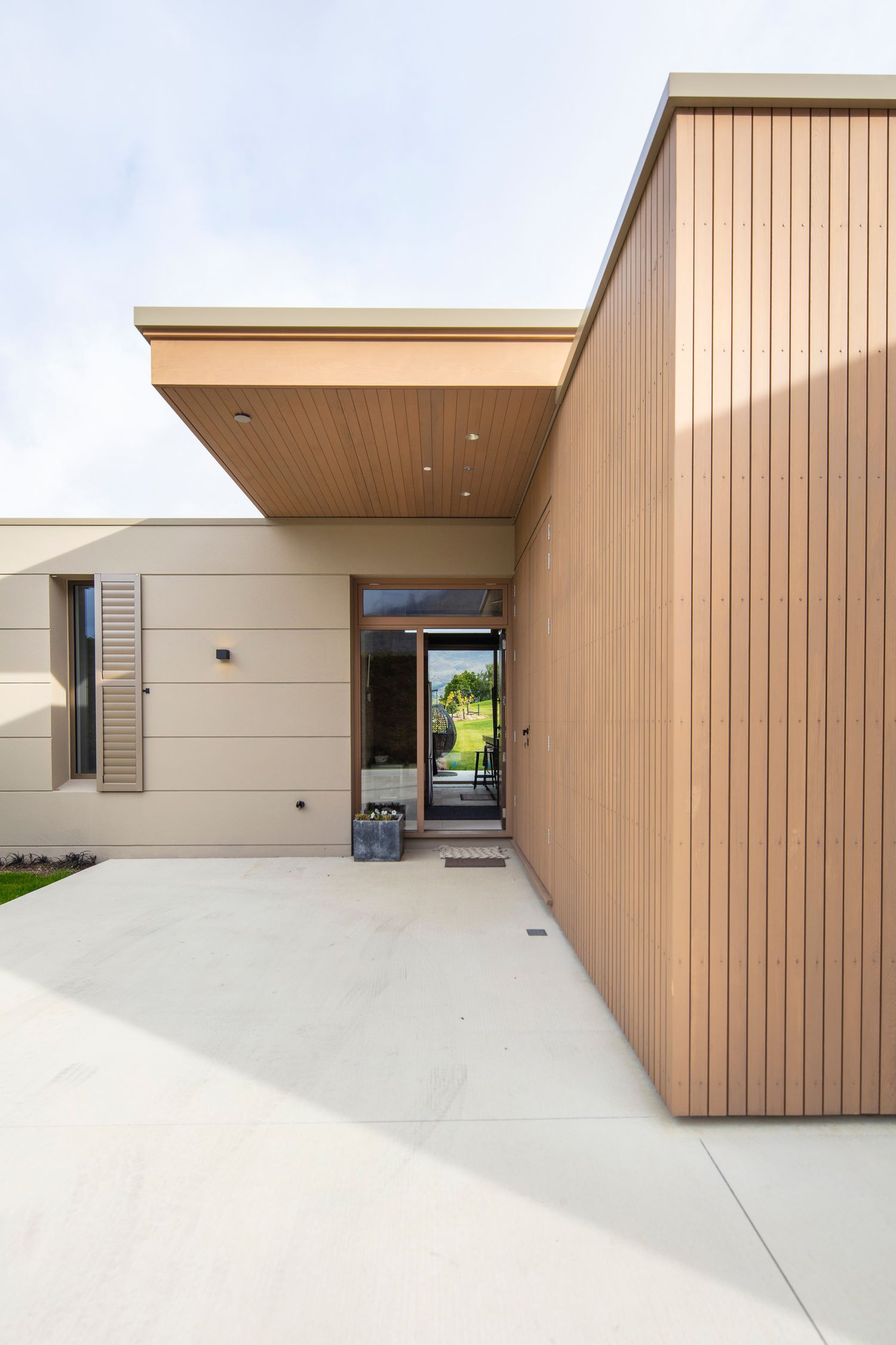 Modern beige wood-paneled exterior facade with minimalist architectural details.