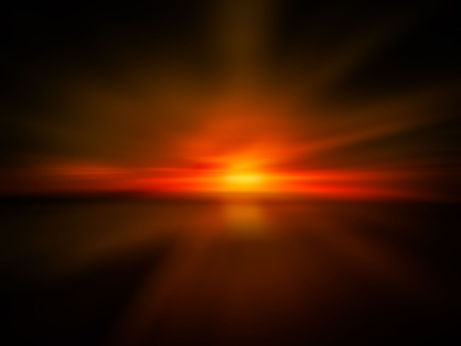 Dramatic orange sunset with light rays bursting through dark horizon.