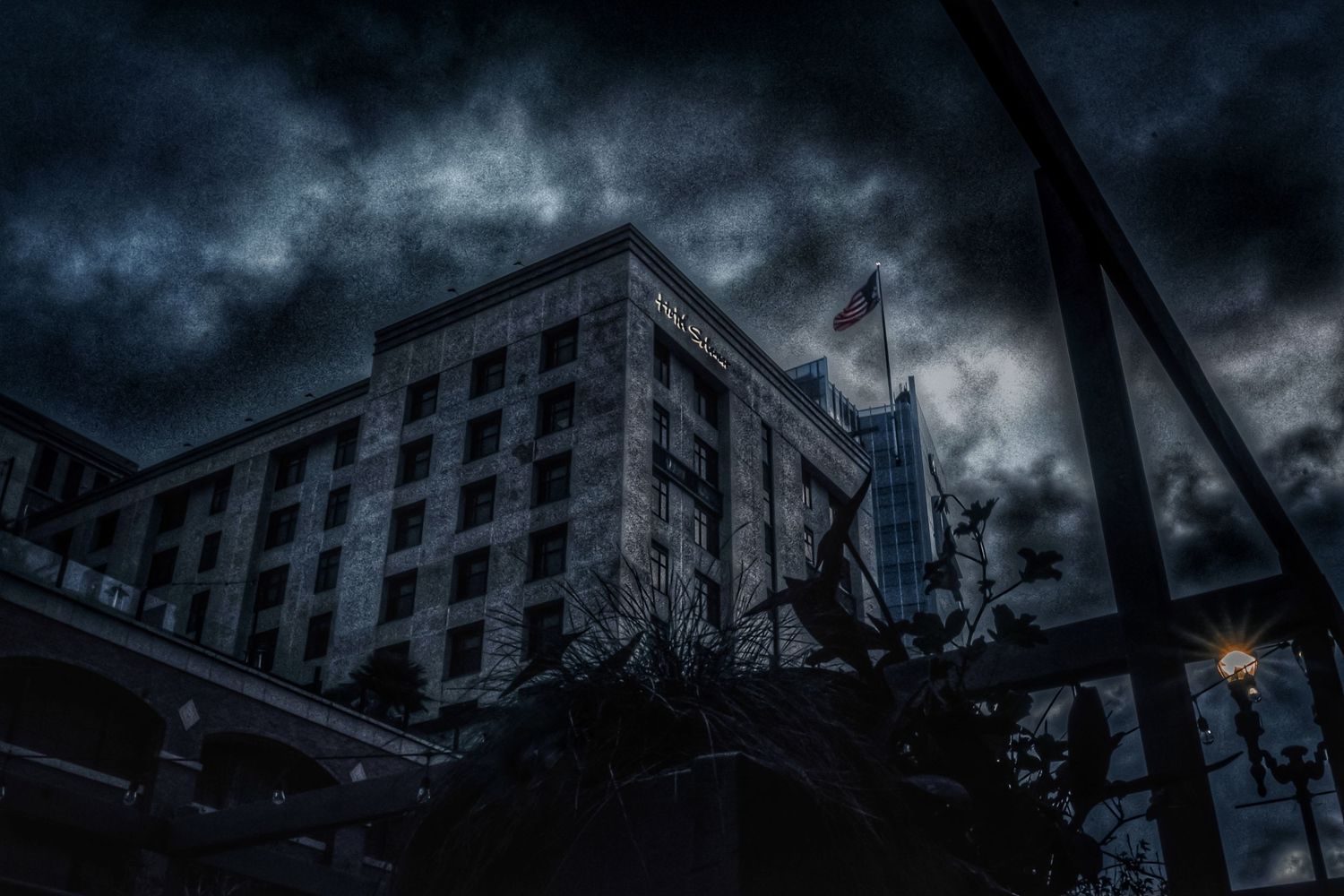 Ominous storm clouds loom over urban buildings creating a dramatic cityscape.