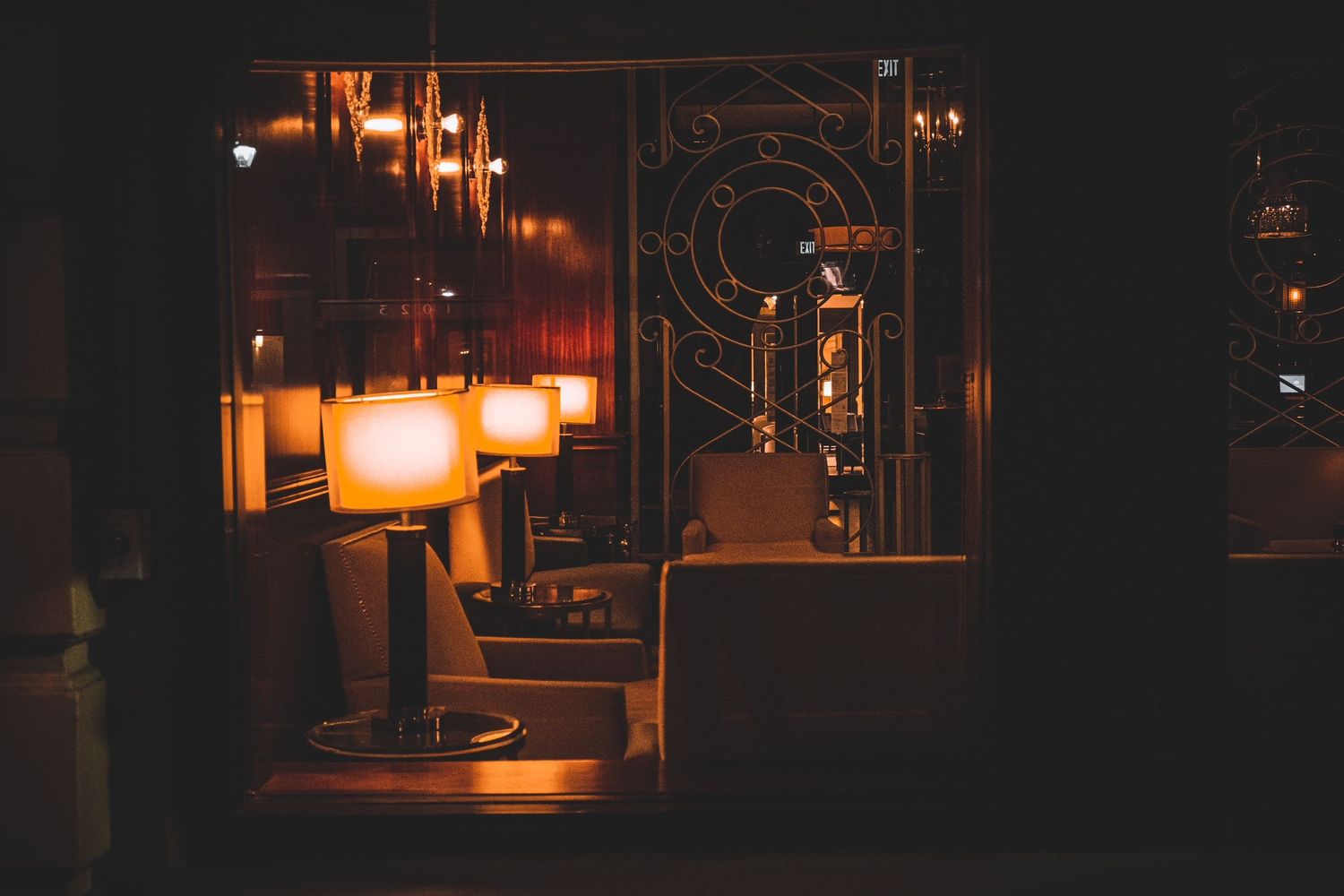 Dimly lit industrial corridor with warm orange lighting creates an atmospheric tunnel effect.
