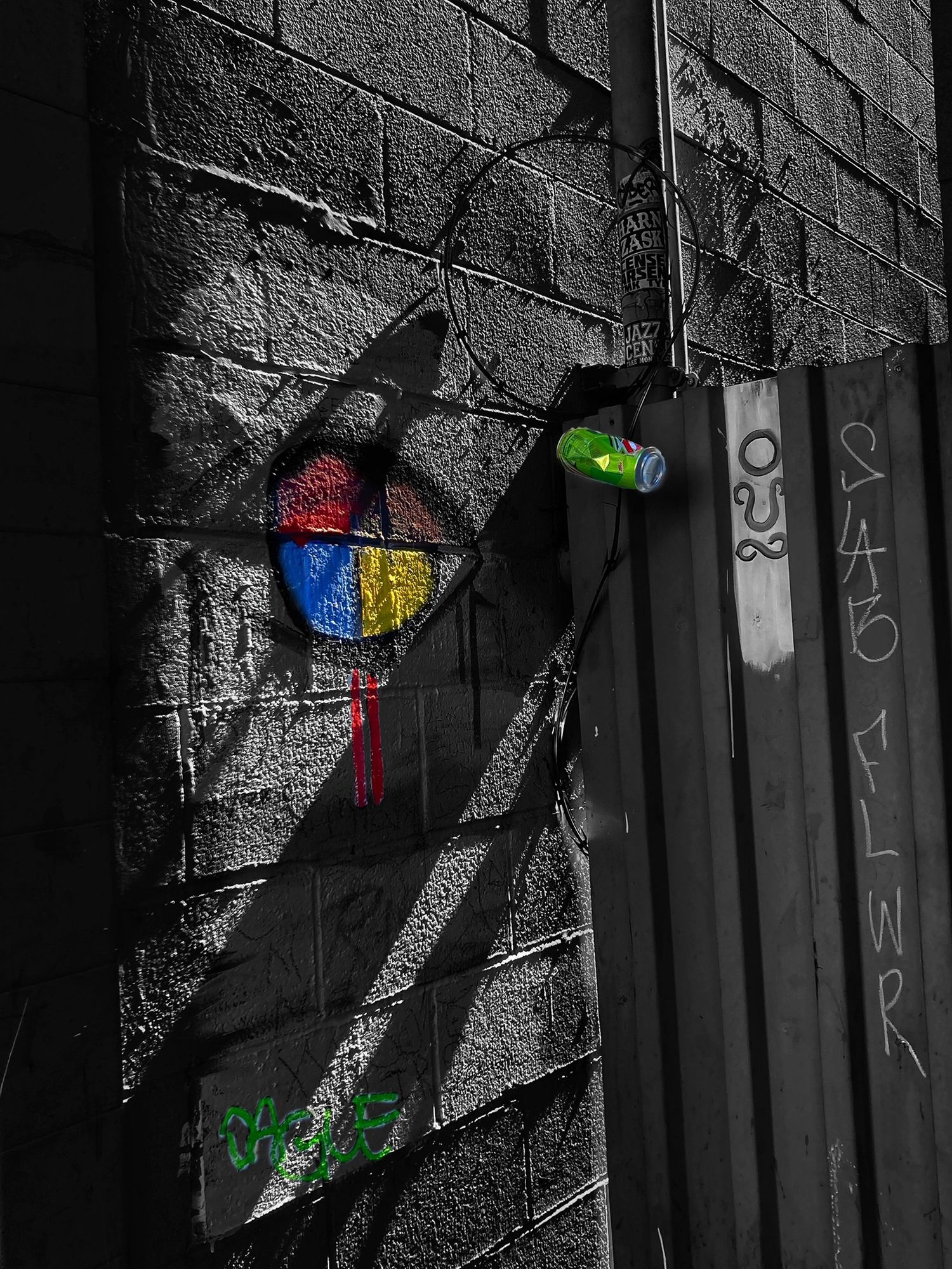 Colorful street art on black and white brick wall with vibrant graffiti elements.