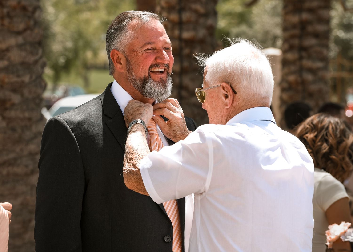 Candid moments shared between wedding guests during an outdoor celebration.