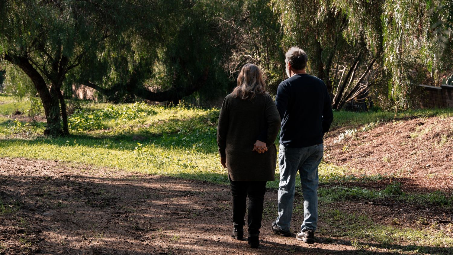 A couple taking a scenic walk in a couples photoshoot in Northern California by Jolie & Rae Photography. Golden Hour morning shoot.