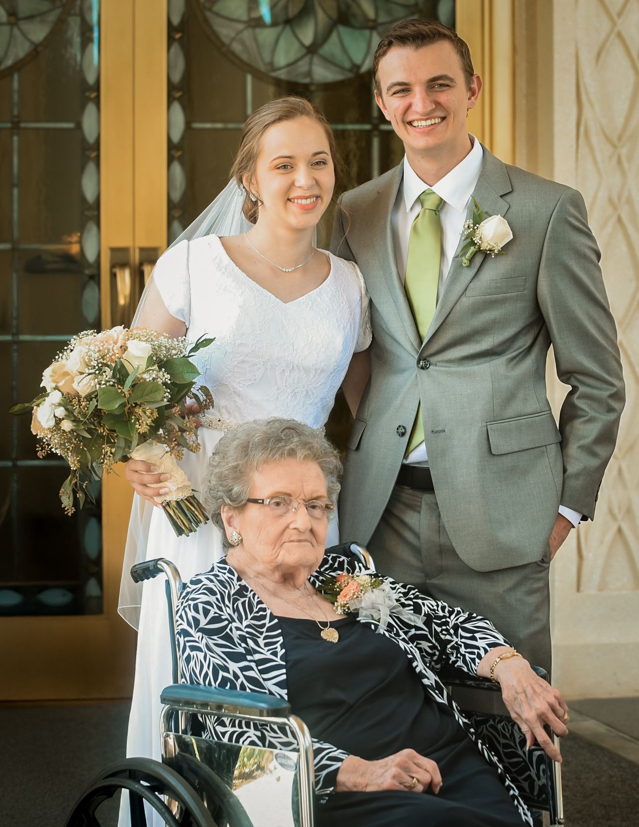 Wedding party members gathered indoors with elegant decor and formal attire.