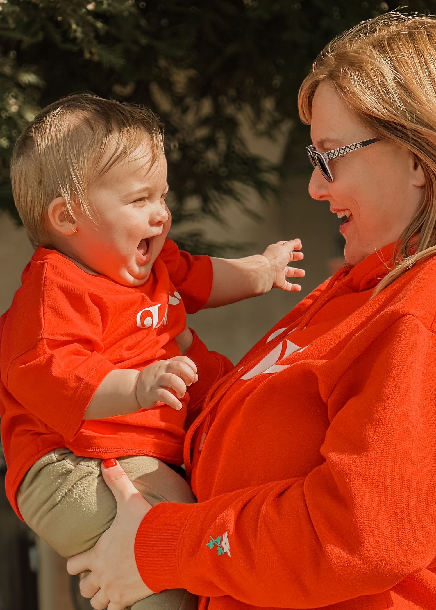 Grandmother holding baby outdoors, candid family moment natural light infant photography taken by Jolie & Rae Photography near Sacramento CA