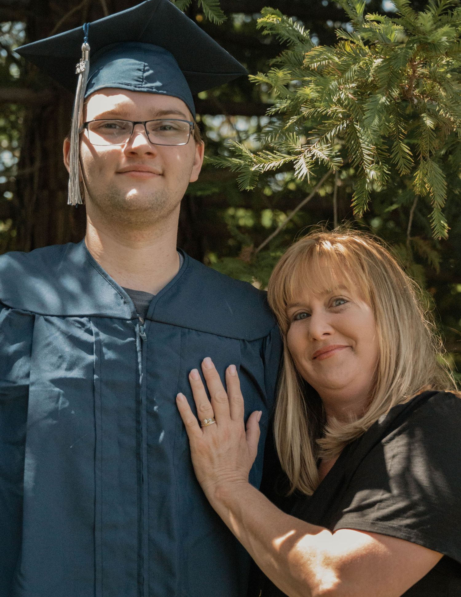Graduate posing with mother outdoors, senior portrait session in Natural Lighting and landscape near Granite Bay CA, Jolie & Rae Photography