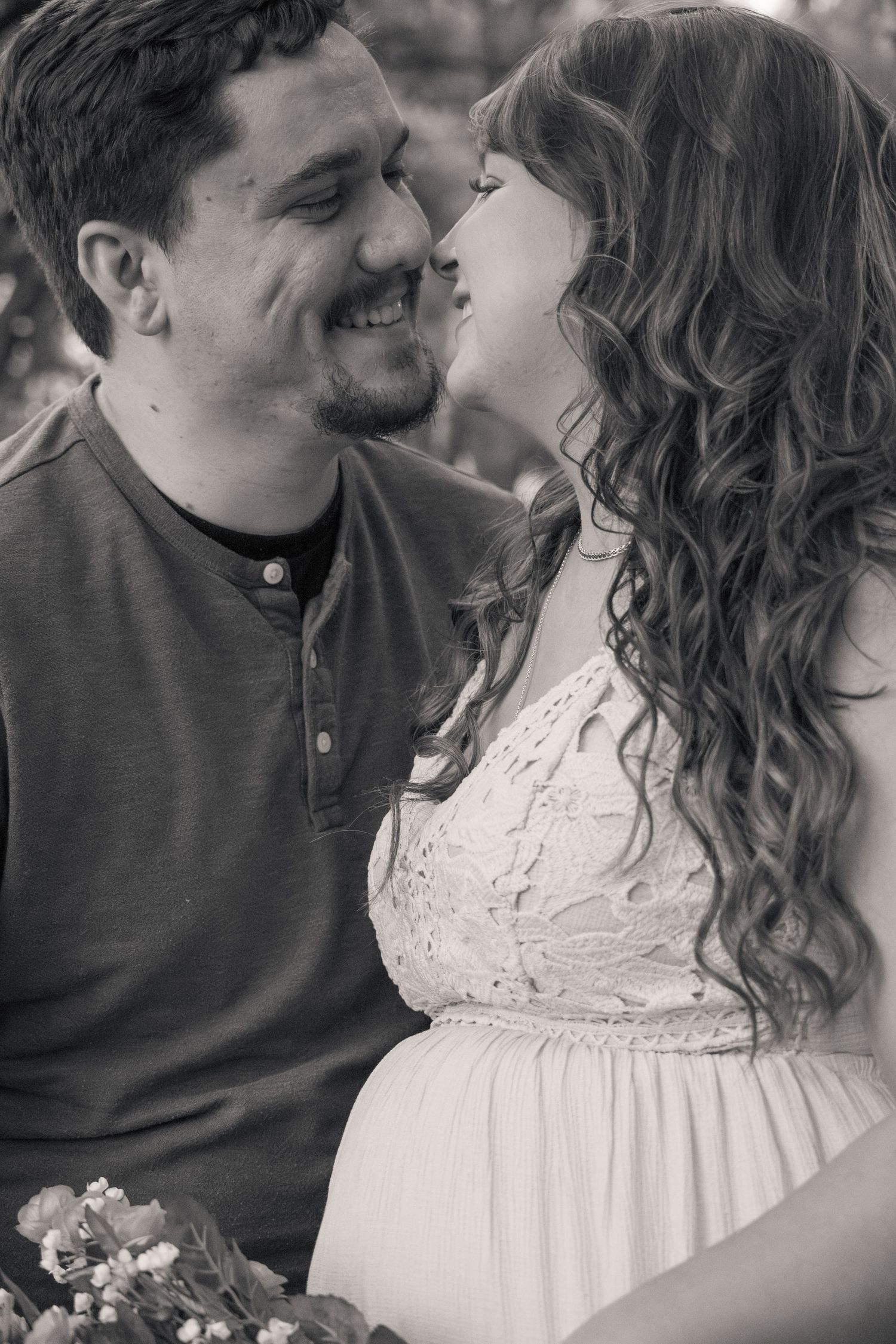 A romantic black and white photo series showing tender moments between a couple with the woman wearing a white lace dress.