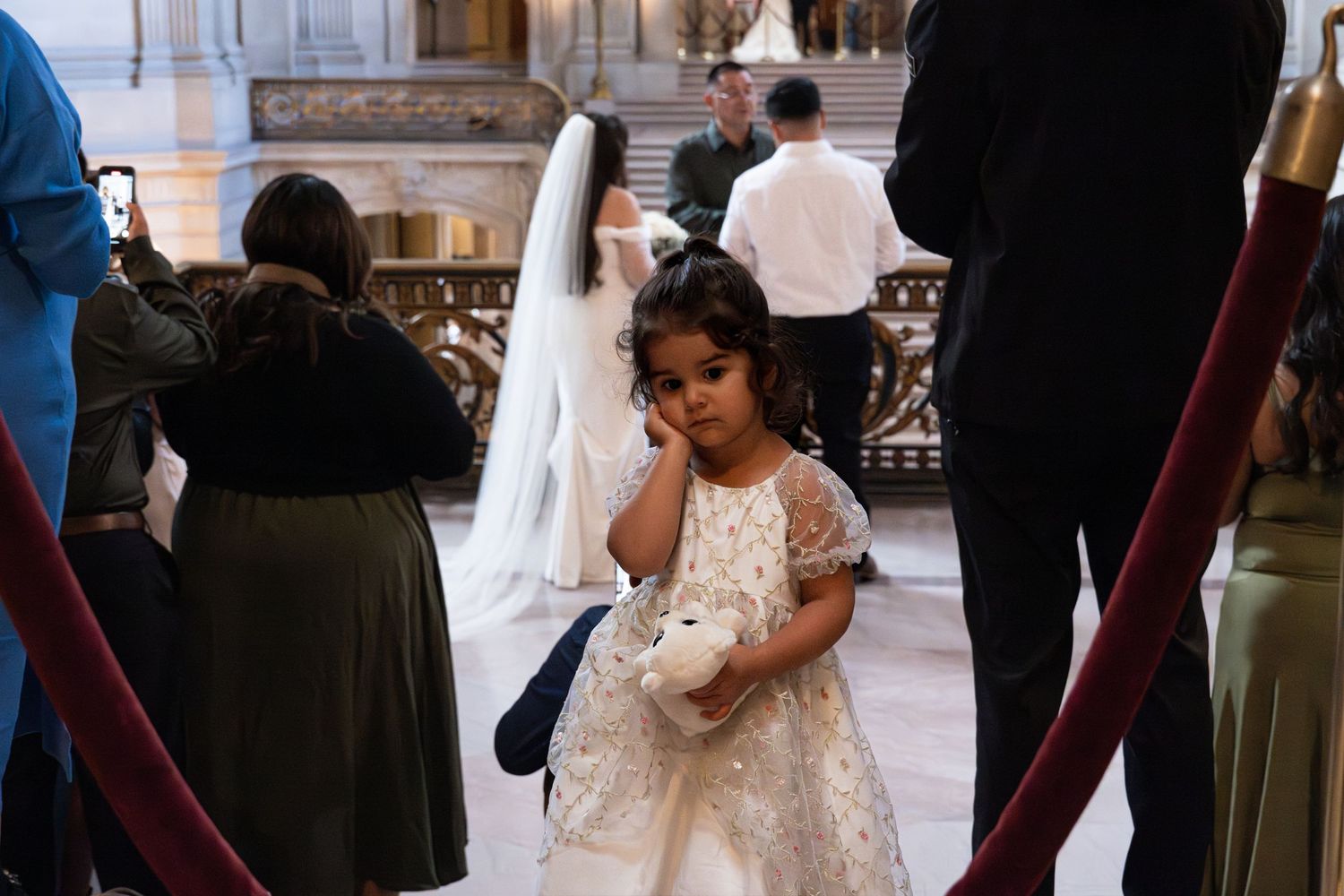 A wedding celebration scene with guests in formal attire in an elegant indoor setting. Children's Photography near Sacramento CA
