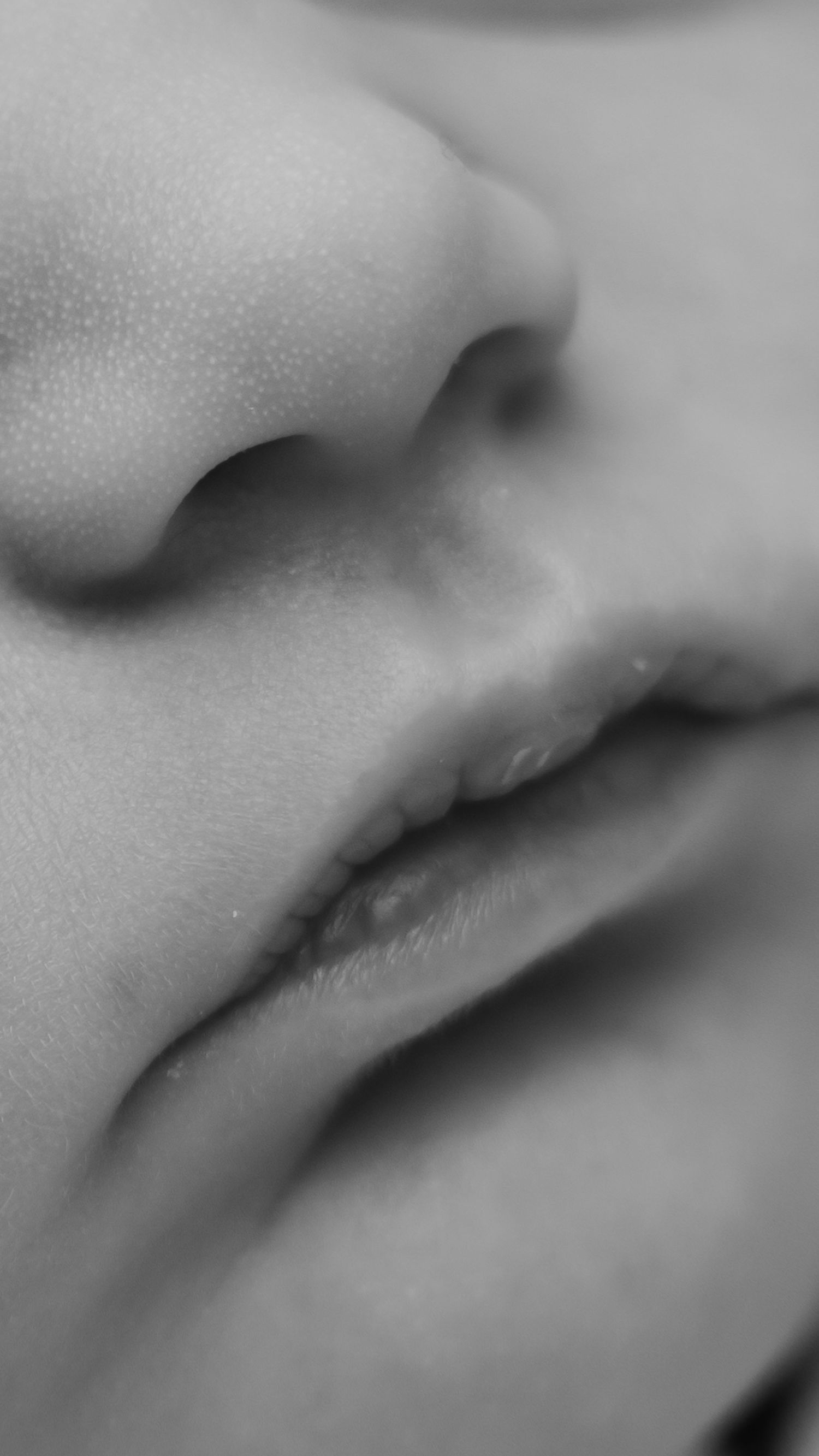 Close-up black and white macro photo of a newborn baby's nose and lips showing delicate skin texture. Fresh-48 photography, Sacramento, CA