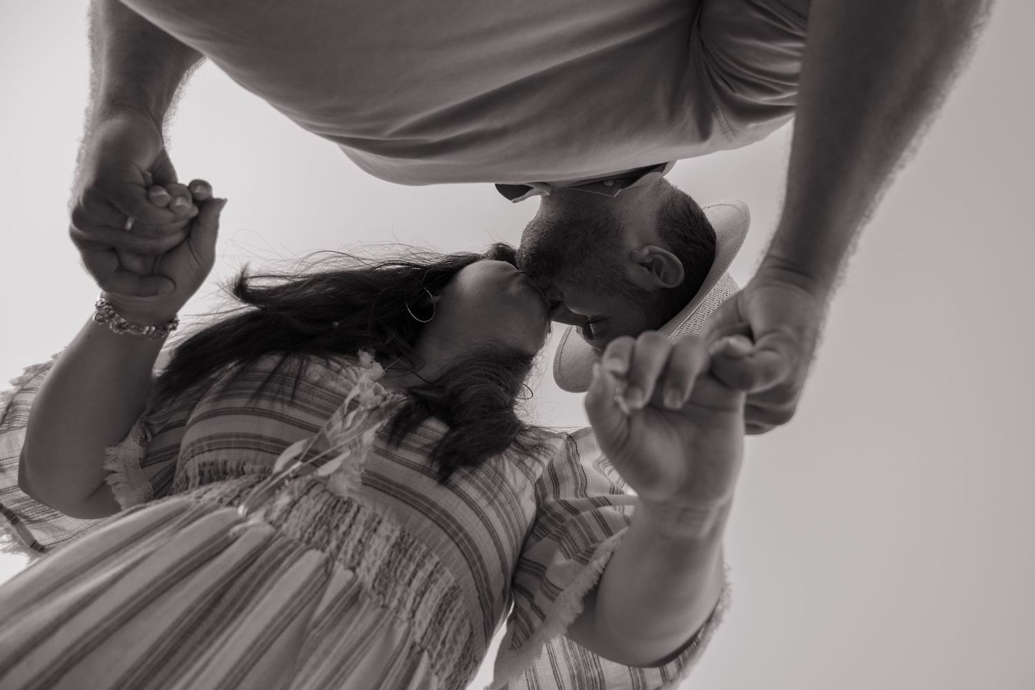 Black and white artistic close-up photograph showing tender interaction between two people.